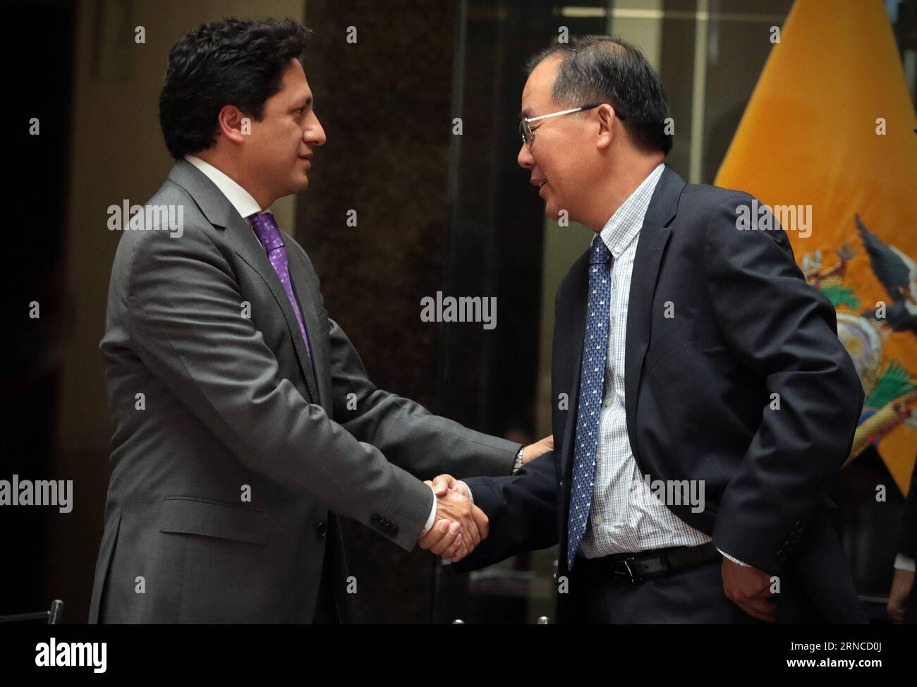 QUITO, April 4, 2016 -- Chen Weilong (R), representative of China s Sinopec International and a member of Penaturi Consortium, shakes hands with Rafael Poveda, coordinating minister of strategic sectors of Ecuador, after the signing of a service contract in the Protocolar Hall of Ecuador s Vicepresidency, in Quito, capital of Ecuador, on April 4, 2016. Ecuador s government-owned Petroamazonas signed nine service contracts on Monday with international consortiums in efforts to develop its mature oil fields. Panaturi Consortium, made up of China s Sinopec International and Sinopec Service Ecuado Stock Photo