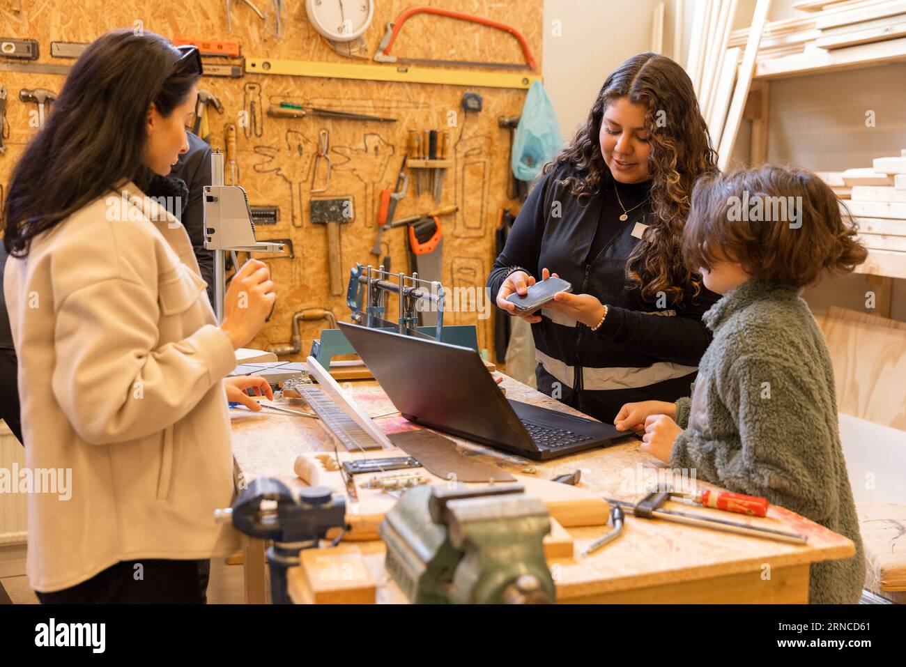 Female technician discussing over electronic goods with boy at recycling center Stock Photo