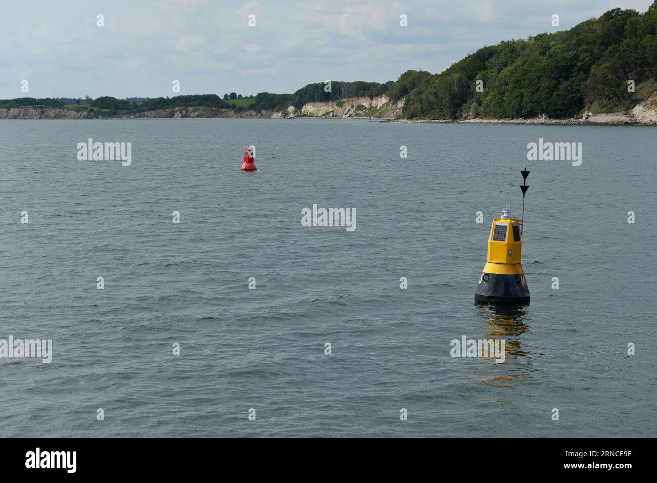 At the head of the Sassnitz Harbor's pier, two buoys are placed to mark the entrance area for ships. Stock Photo
