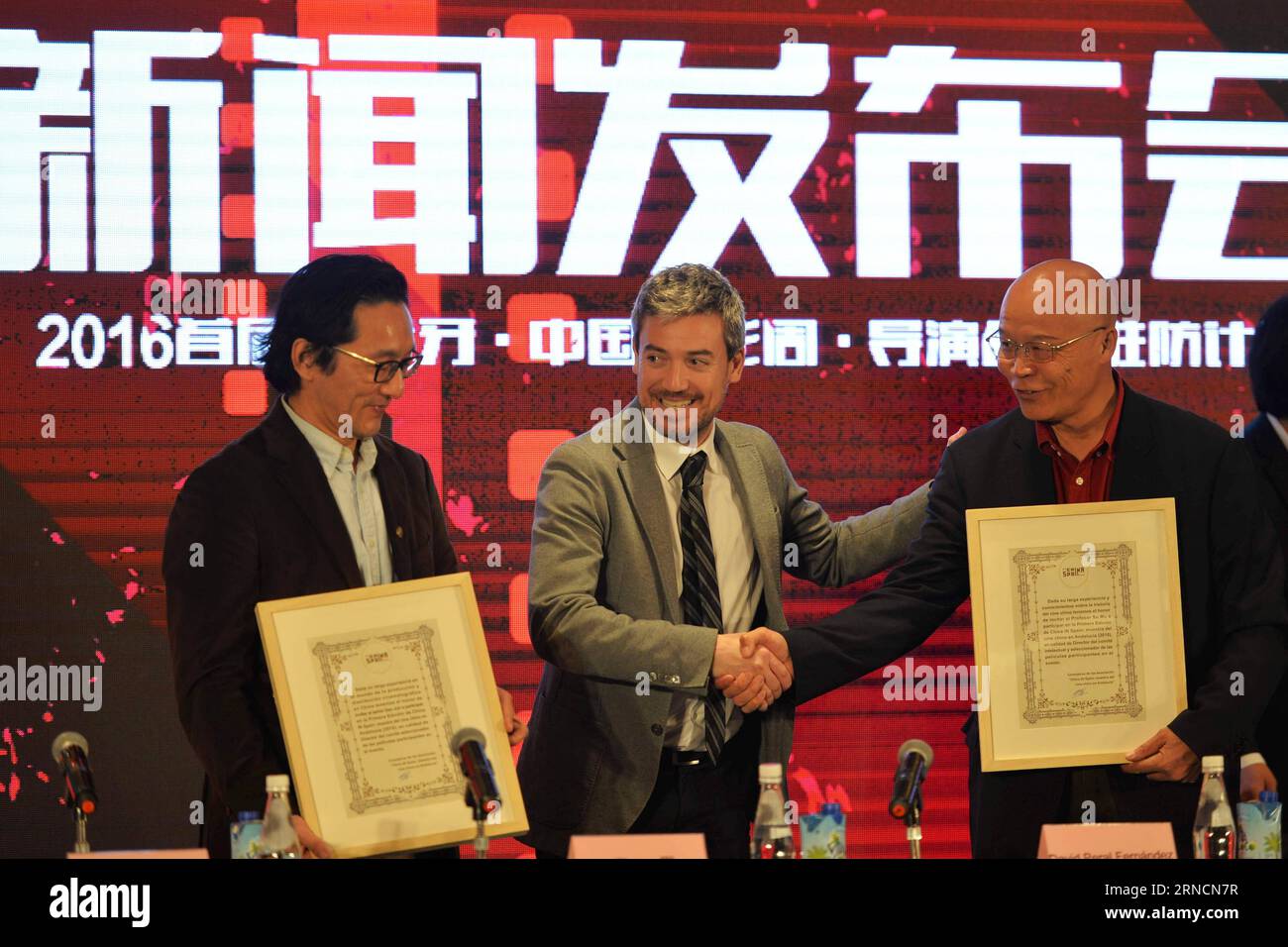 (160417) -- BEIJING, April 17, 2016 -- David Peral Fernandez (C), cultural minister of the Andalucia region in Spain, issues letters of appointment to Chinese filmmakers during a press conference of the first Sino-Spanish film culture exchange project in Beijing, capital of China, April 17, 2016. According to the project, ten Chinese films will be shown during the first Sino-Spanish film week in majors cities of Spain s Andalucia region in November of 2016. Moreover, the Barcelona government will invite Chinese young directors for a one-month shooting project with Spanish directors. )(wjq) CHI Stock Photo