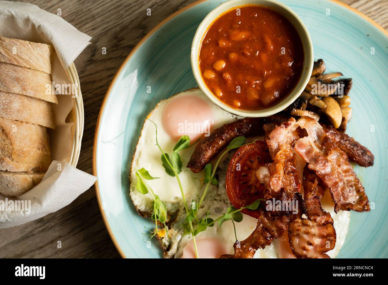 English Breakfast with fried eggs, bacon, Hungarian sausage, mushrooms
