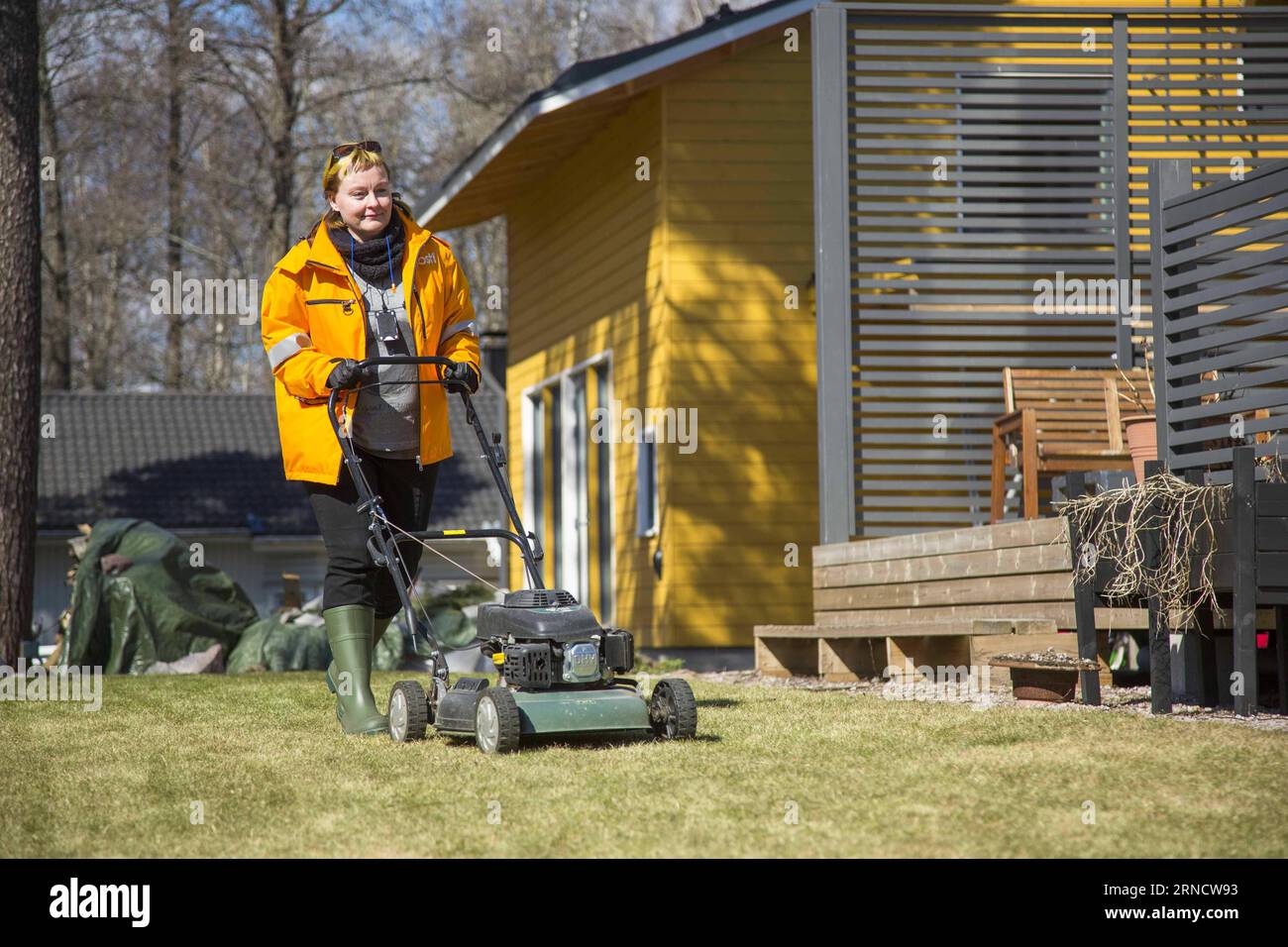 (160422) -- HELSINKI, April 22, 2016 -- Photo provided by the The , Posti on April 21 shows a postwoman mowing lawns at a house in Finland. People who want their lawns mowed during the summer will now be able to ask a postman or postwoman to do it. The , Posti, is launching a service offering lawn mowing as part of its Tuesday deliveries. FINLAND-HELSINKI-POST OFFICE-LAWN MAWING SERVICE Finnishxpostxoffice PUBLICATIONxNOTxINxCHN   160422 Helsinki April 22 2016 Photo provided by The The Posti ON April 21 Shows a Woman post mowing lawns AT a House in Finland Celebrities Who want their lawns mowe Stock Photo