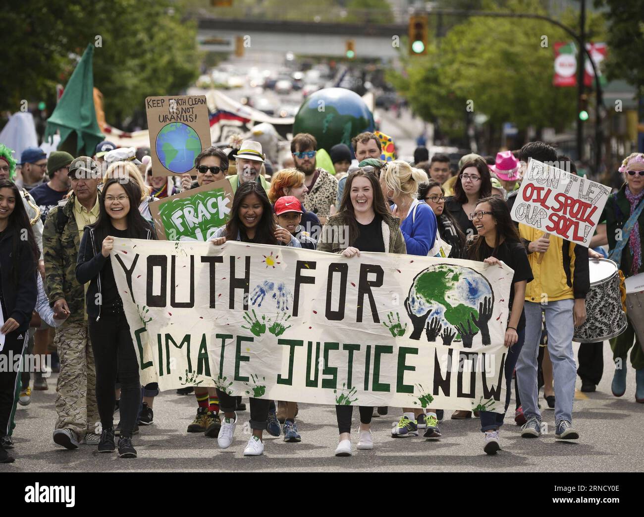 Participants carry a banner together during the Earth Day parade held ...