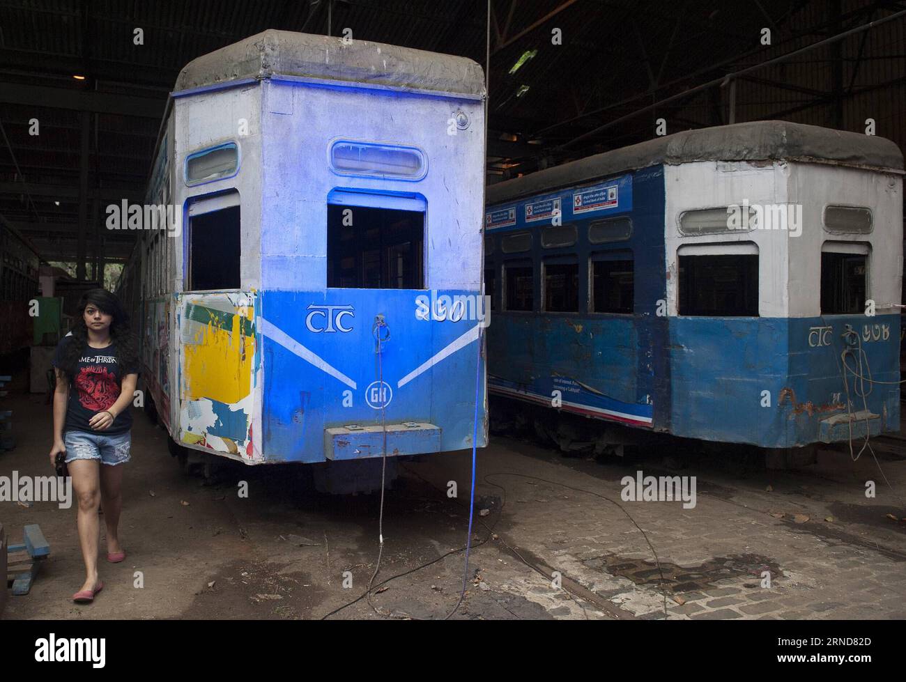 (160509) -- KOLKATA, May 9, 2016 -- A visitor walks beside tramcars during the two-day event Tram Tales at a tram depot in Kolkata, capital of eastern Indian state West Bengal, May 8, 2016. Tram Tales was planned as a unique mixed - media interactive visual installation piece using videos, music, photography, games, food and interaction to celebrate the nostalgia of trams as a symbol of Kolkata s rich colonial-era heritage. The event was held from May 7 to 8. ) INDIA-KOLKATA-TRAM TALES TumpaxMondal PUBLICATIONxNOTxINxCHN   160509 Kolkata May 9 2016 a Visitor Walks Beside tramcars during The Tw Stock Photo