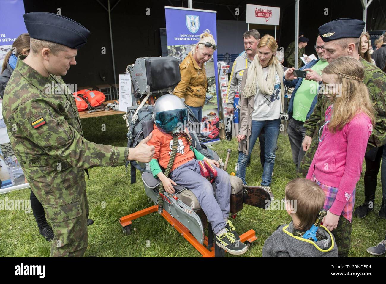 (160515) -- VILNIUS, May 14, 2016 -- A child is experiencing the seat of military aircraft in Vilnius, Lithuania, May 14, 2016. Lithuania celebrates Armed Forces and Public Unity Day in it s captial on Saturday. Troops of Lithuania, Germany, U.S., Luxembourg, Portugal, etc. brought their light weapons, military vehicles and other equipment to the public. Fighting Falcon F-16 of Portuguese air force and Black Hawk of the U.S. air force participated in the performance. ) LITHUANIA-VILNIUS-ARMED FORCES AND PUBLIC UNITY DAY AlfredasxPliadis PUBLICATIONxNOTxINxCHN   160515 Vilnius May 14 2016 a Chi Stock Photo