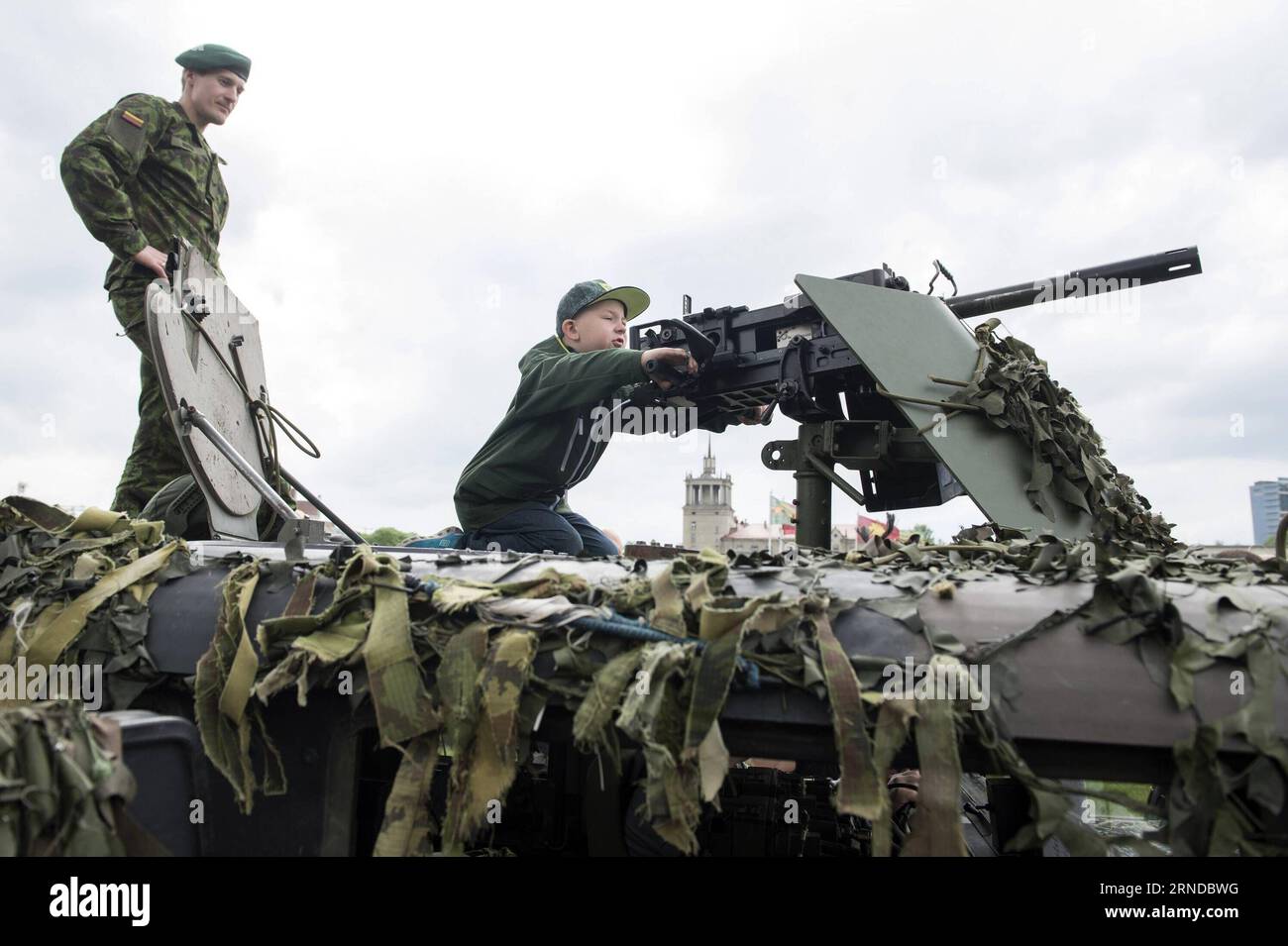 (160515) -- VILNIUS, May 14, 2016 -- A child is experiencing a machine gun of a military vehicle in Vilnius, Lithuania, May 14, 2016. Lithuania celebrates Armed Forces and Public Unity Day in it s captial on Saturday. Troops of Lithuania, Germany, U.S., Luxembourg, Portugal, etc. brought their light weapons, military vehicles and other equipment to the public. Fighting Falcon F-16 of Portuguese air force and Black Hawk of the U.S. air force participated in the performance. ) LITHUANIA-VILNIUS-ARMED FORCES AND PUBLIC UNITY DAY AlfredasxPliadis PUBLICATIONxNOTxINxCHN   160515 Vilnius May 14 2016 Stock Photo