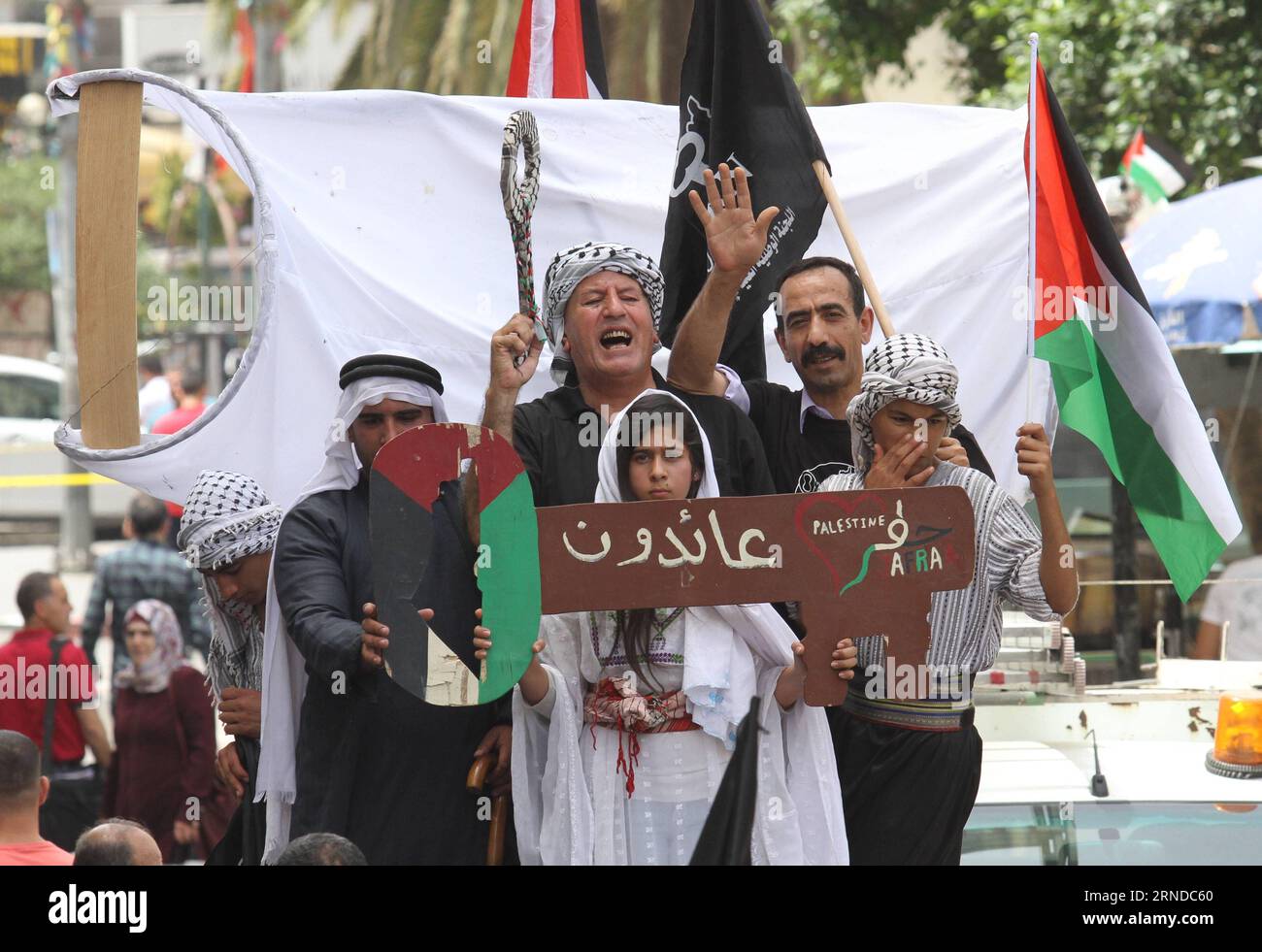 (160515) -- NABLUS, May 15, 2016 -- Palestinians hold a large key, symbolising the homes left by Palestinians in 1948, during a rally to commemorate the 68th anniversary of Nakba, meaning catastrophe, the day when the state of Israel was created, in the West Bank city of Nablus, on May 15, 2016. Since 1948, the Palestinians all over the world mark Nakba on May 15. According to the Palestinian Statistics Bureau Center, 957,000 Palestinians left their homes in towns, cities and villages in 1948, which represents 66 percent of the total number of Palestinians who lived in historic Palestine at th Stock Photo