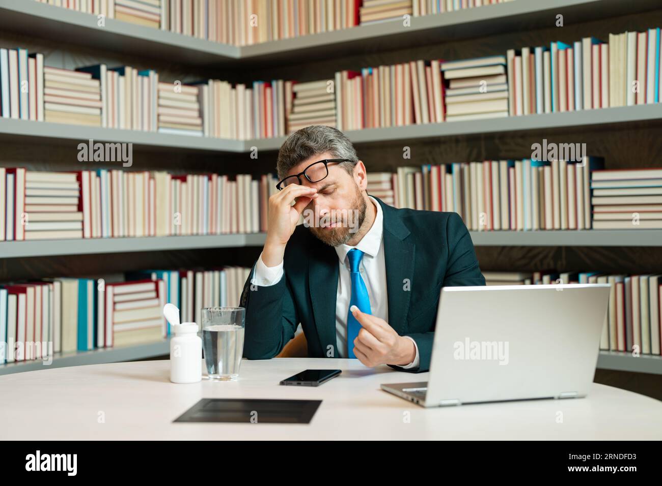 Business man suffering from headache after computer work, exhausted ...