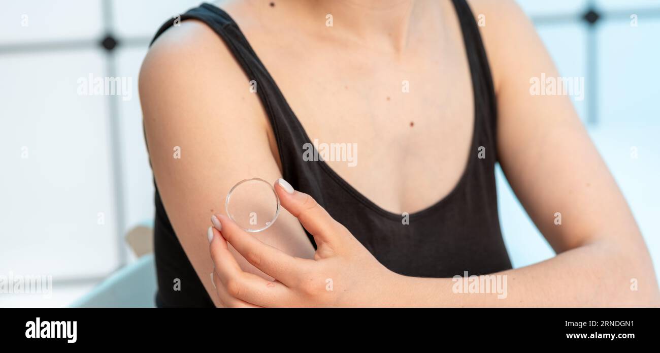 young woman uses gel transdermal microneedle patch Stock Photo