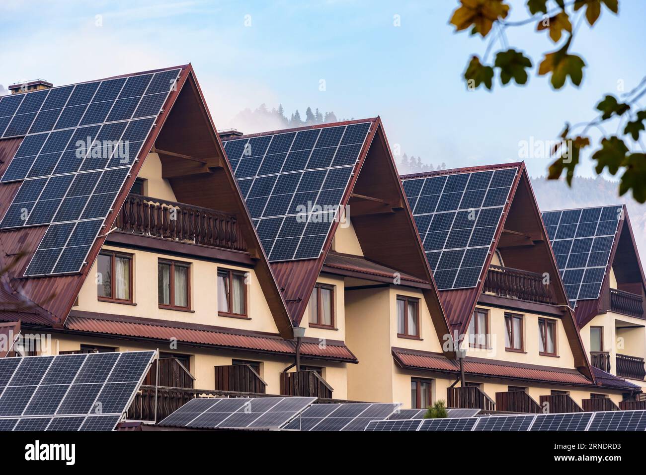 Sloping mountain house roof covered with photovoltaic panels Stock Photo