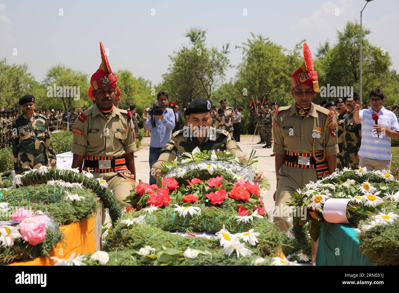 (160604) -- SRINAGAR, June 4, 2016 -- An officer of India s Border Security Force (BSF) lays a floral wreath in front of coffins of slain border guards during a wreath laying ceremony at a BSF camp in the outskirts of Srinagar, summer capital of Indian-controlled Kashmir, June 4, 2016. The militant attack on convoy of India s Border Security Force (BSF) on Friday left three border guards dead and nine others wounded, two of them critically, in restive Indian-controlled Kashmir, officials said. ) (cyc) INDIA-KASHMIR-SRINAGAR-MILITANT ATTACK JavedxDar PUBLICATIONxNOTxINxCHN   160604 Srinagar Jun Stock Photo