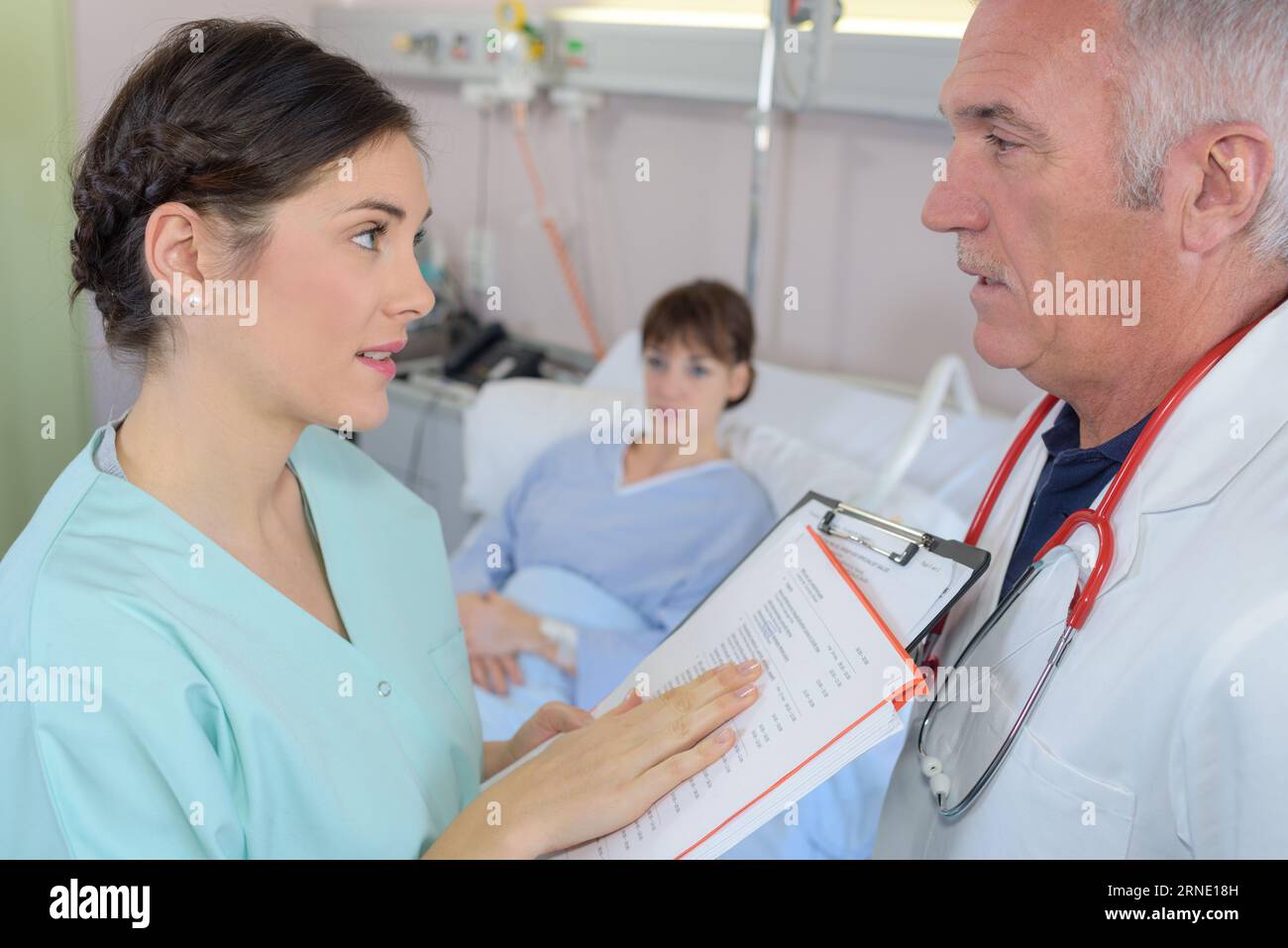 Doctor talking pretty nurse hi-res stock photography and images - Alamy