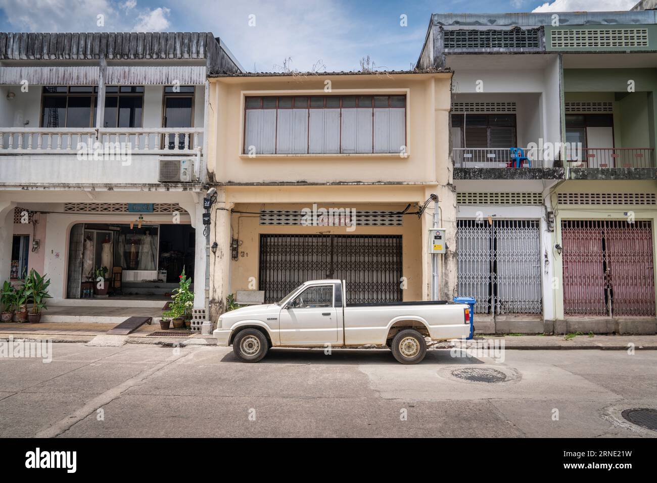 Architecture in Takua Pa. An old pickup truck on the background of buildings in the Chinese-Portuguese style. Takua Pa Thailand, Phang Nga March 2, 20 Stock Photo