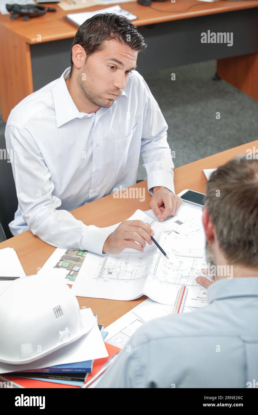 Architect explaining something to clien Stock Photo - Alamy