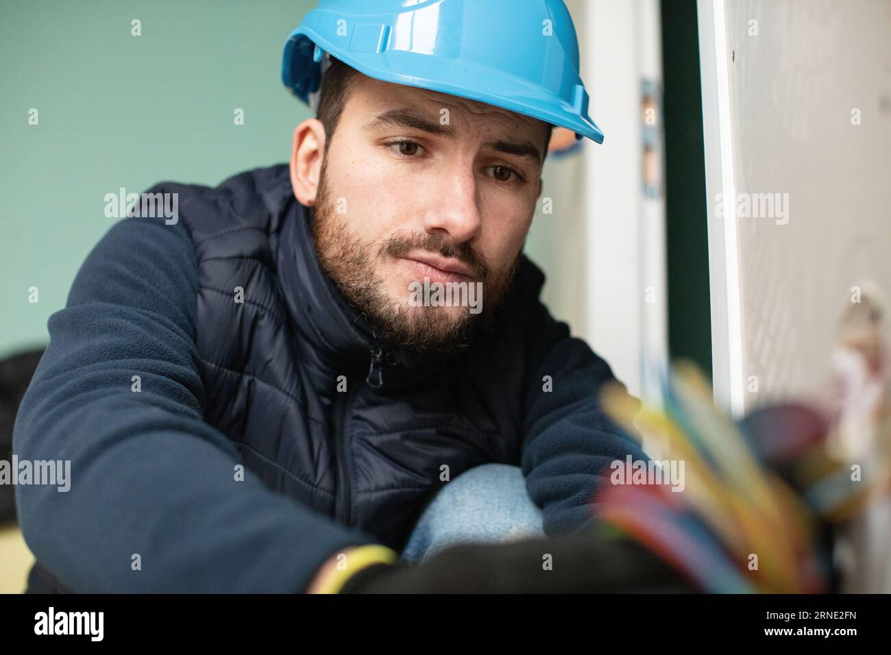 handsome electrician repairing electrical box Stock Photo