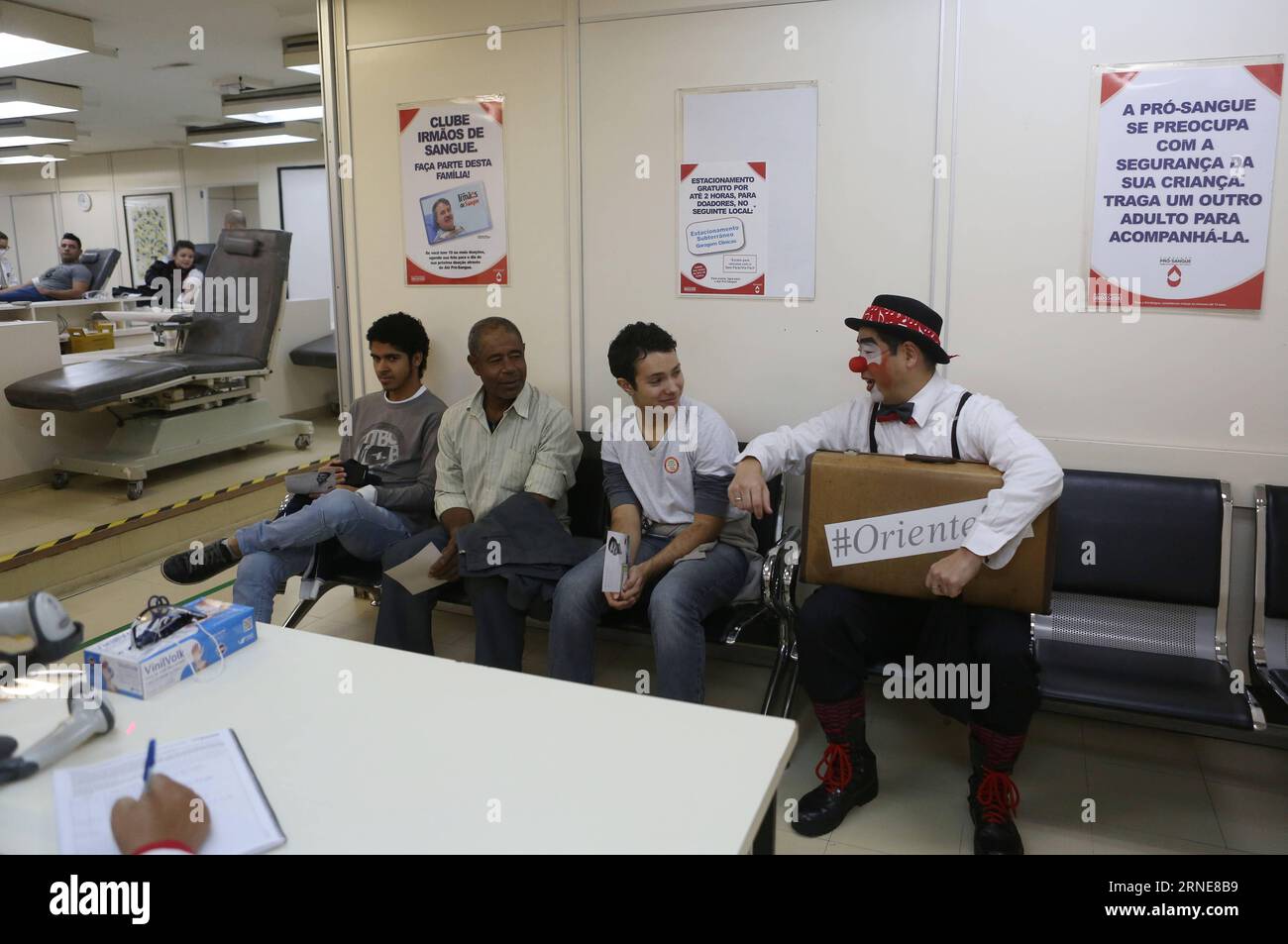 (160614) -- SAO PAULO, June 14, 2016 -- Image taken on June 9, 2016, shows Gilberto Kido (C), 50, talking to other blood donors in the waiting room at the Pro Sangre Foundation in Sao Paulo, Brazil. Gilberto Kido has been a voluntary blood donor for the last 30 years after his mother died while waiting for a kidney transplant. Using his clown character, Kido has an objective to encourage the blood donation for saving lives. The World Blood Donor Day is celebrated every year on June 14. In 2016 the theme of the campaign is Blood connects us all , the World Health Organization (WHO) has also ado Stock Photo
