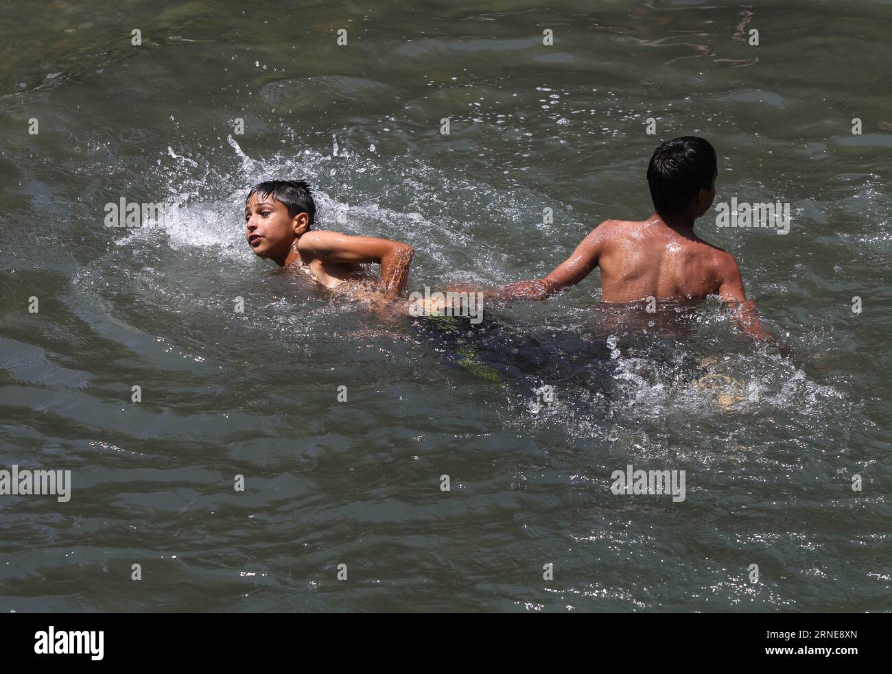 (160614) -- SRINAGAR, June 14, 2016 -- Kashmiri children bathe in a stream on a hot summer day on the outskirts of Srinagar, summer capital of Indian-controlled Kashmir, June 14, 2016. As Indian-controlled Kashmir witnessed hot weather for the past few days, people took shower in streams to beat the heat. ) KASHMIR-SRINAGAR-HOT WEATHER JavedxDar PUBLICATIONxNOTxINxCHN   160614 Srinagar June 14 2016 Kashmiri Children Bathe in a Stream ON a Hot Summer Day ON The outskirts of Srinagar Summer Capital of Indian Controlled Kashmir June 14 2016 As Indian Controlled Kashmir witnessed Hot Weather for T Stock Photo