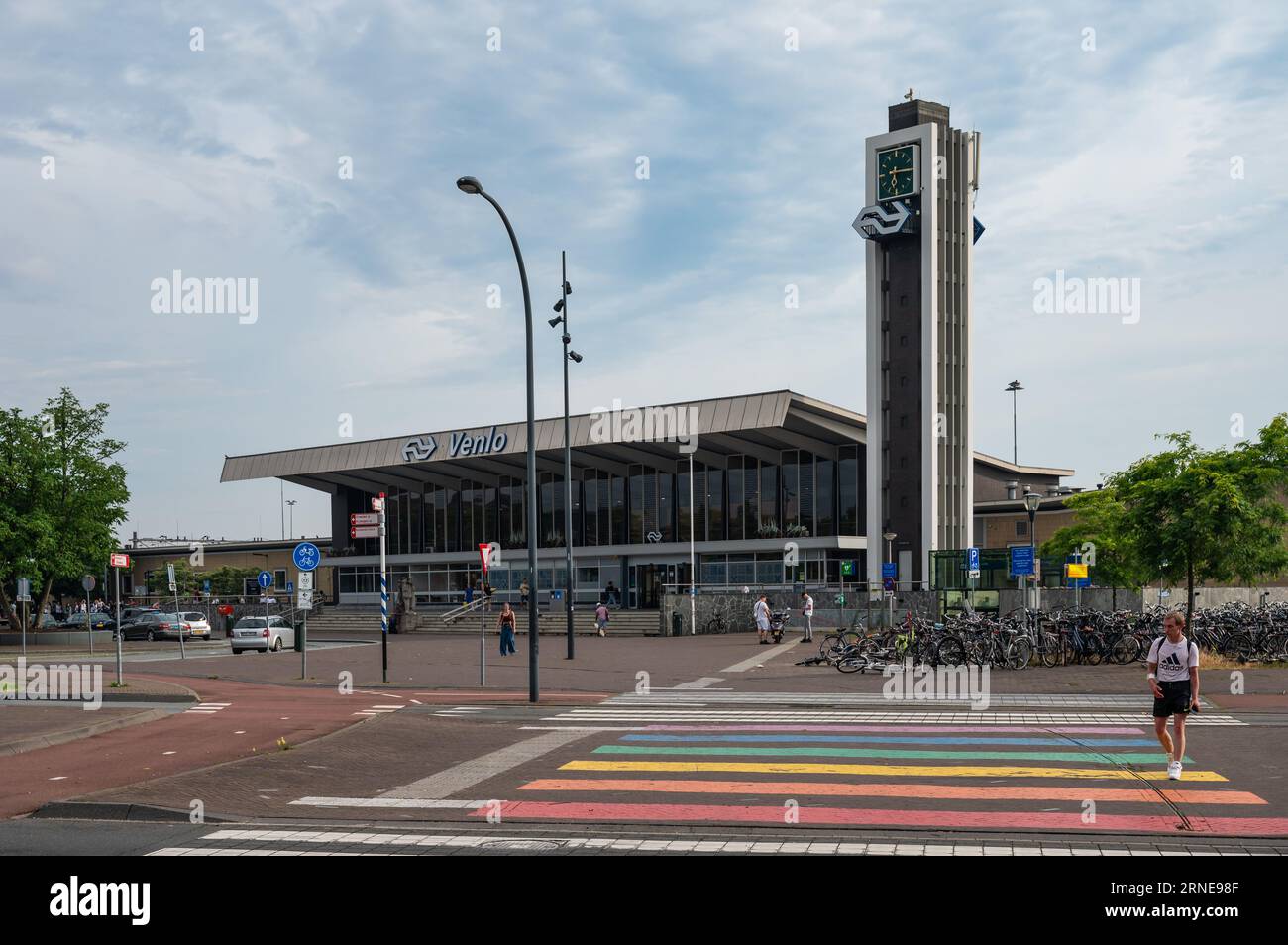 Venlo, Limburg, The Netherlands, July 12, 2023 - Railway station with pedestrian crossing and clock tower Stock Photo