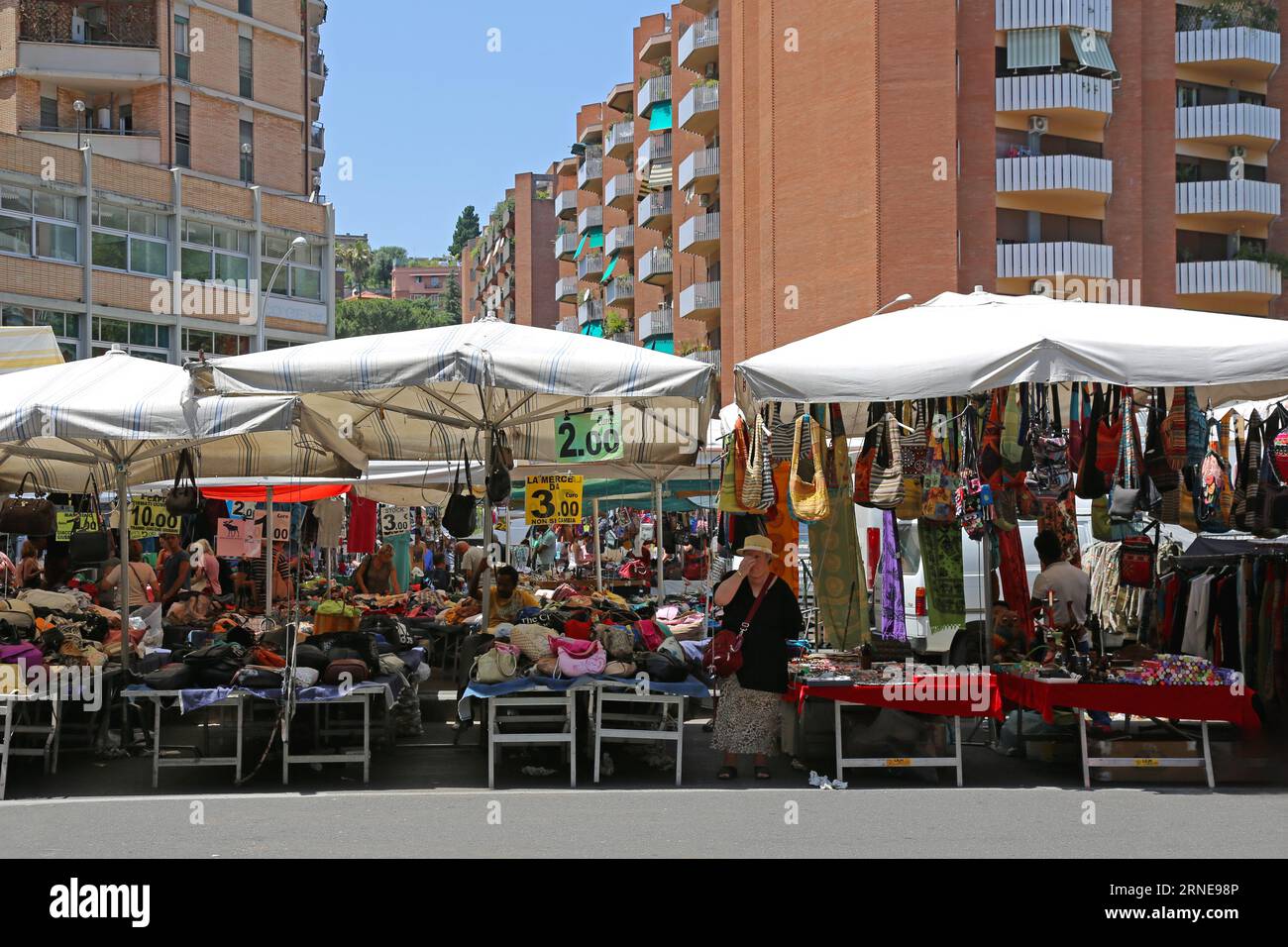 Rome, Italy - June 29, 2014: People Browsing For Cheap Handbags Purses Fashion Accessories at Porta Portese Sunday Flea Market in Capital City Summer. Stock Photo