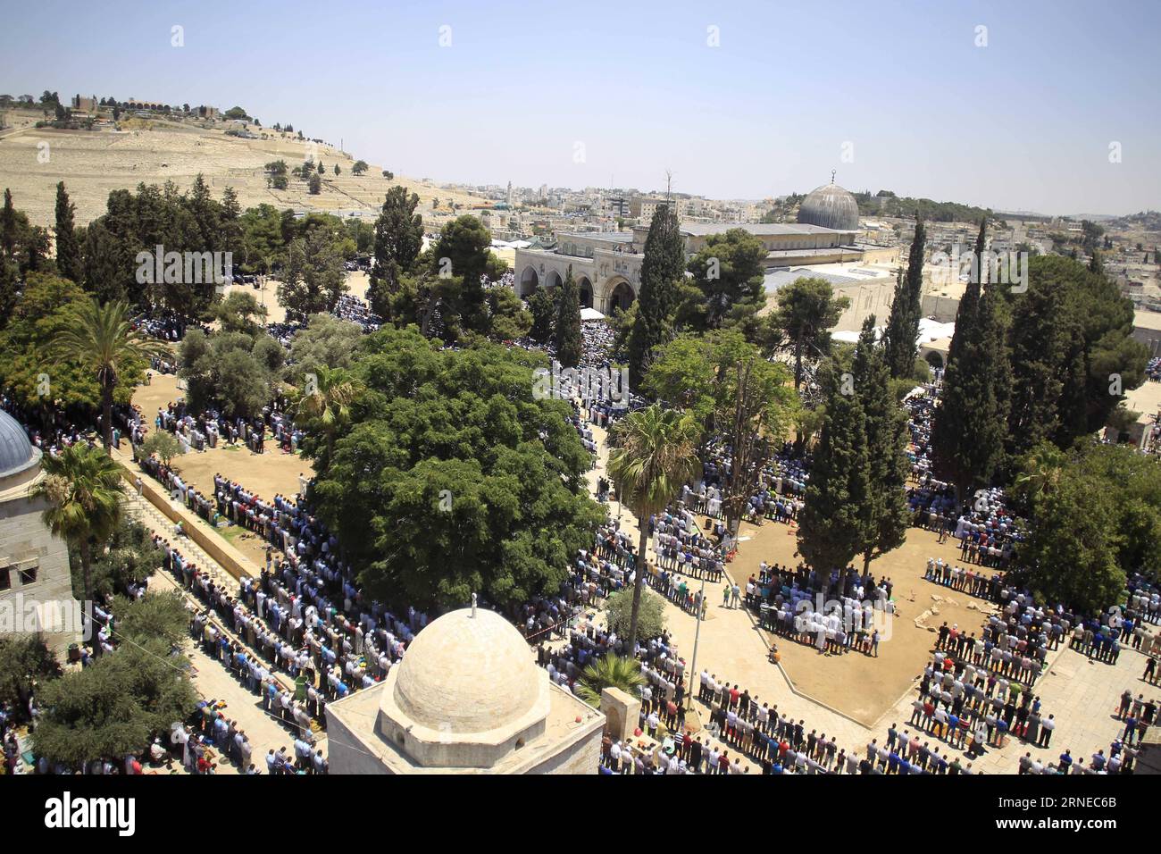 Palestinian Muslim worshippers pray near the rubble of a destroyed