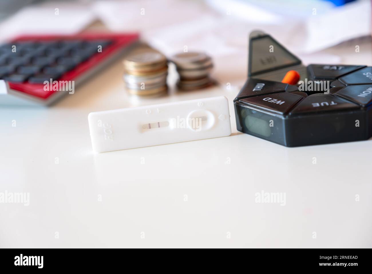 Concept of pregnancy test with supplements represents the costs of