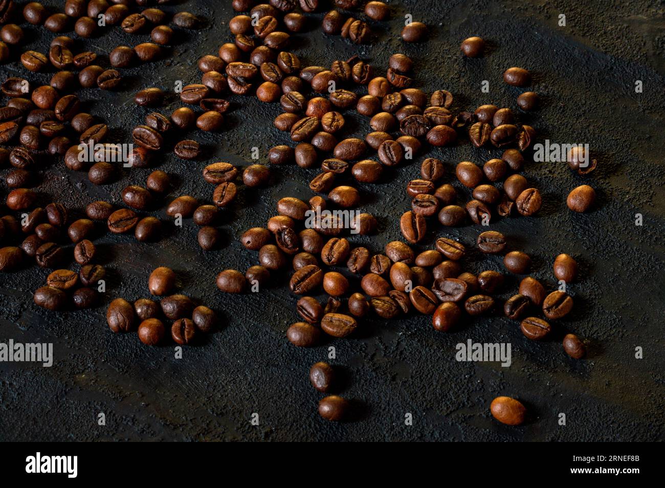 Roasted coffee beans on a black background Stock Photo - Alamy