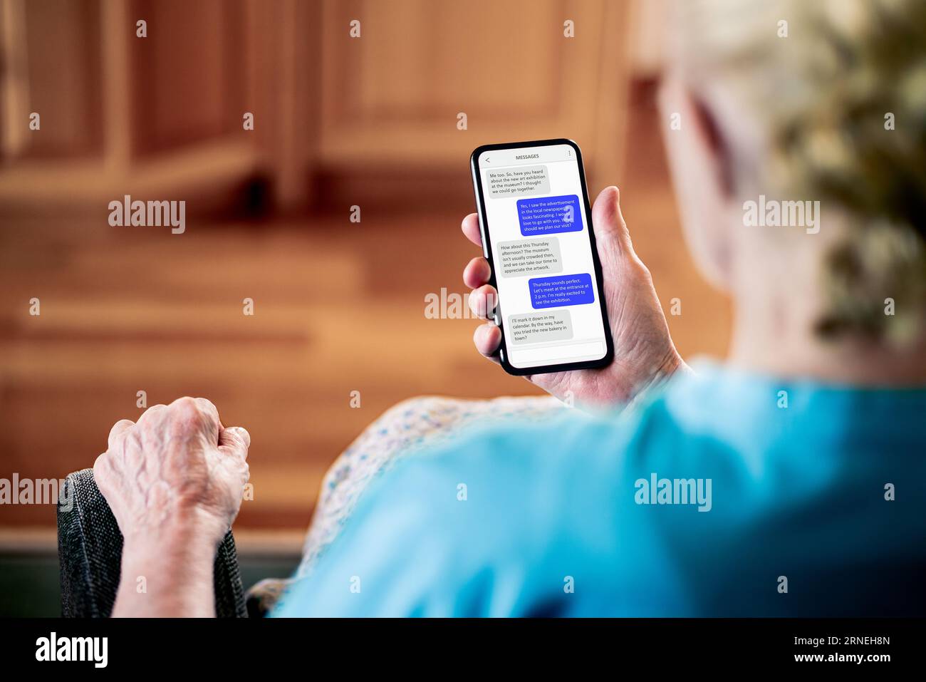 Text or chat messages in phone. Elder senior mature woman sms texting with friend or family. Old lady with cellphone messaging app. Stock Photo