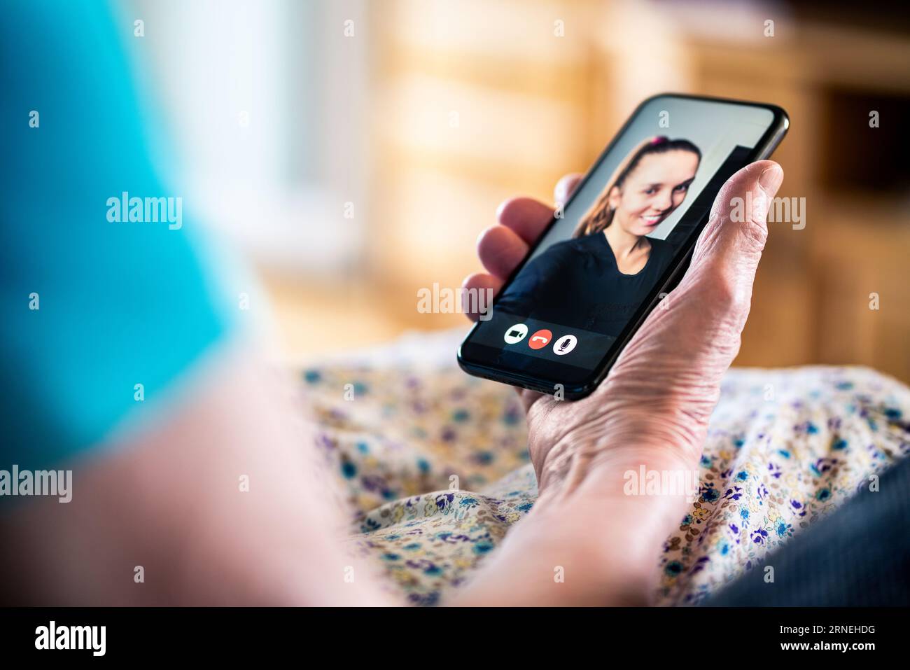 Video call with family. Mobile phone videocall. Old senior lady and young woman. Grandma and granddaughter talking online. Stock Photo