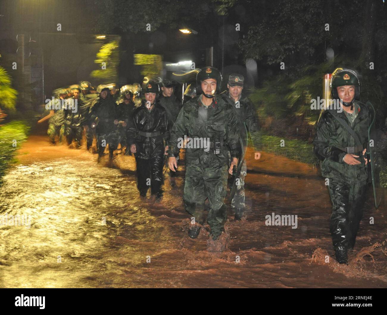 CHONGQING, June 23, 2016 -- Armed policemen gather to reinforce security of Yuxi Prison in Yongchuan of Chongqing, southwest China, June 23, 2016. Heavy rain on Thursday night flooded a section of the outer wall of Yuxi Prison forcing the relocation of 1,400 inmates over night. The prison authority has reinforced security and ensured provisions. )(mcg/yxb) CHINA-CHONGQING-HEAVY RAIN-PRISONER-RELOCATION (CN) ChenxCheng PUBLICATIONxNOTxINxCHN   Chongqing June 23 2016 Armed Policemen gather to reinforce Security of Yuxi Prison in Chuan Yong of Chongqing Southwest China June 23 2016 Heavy Rain ON Stock Photo
