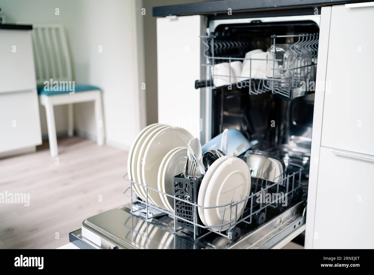 Dish washing machine. Washer in kitchen. Open dishwasher in modern white  home. Full of clean plates. House interior and household technology Stock  Photo - Alamy