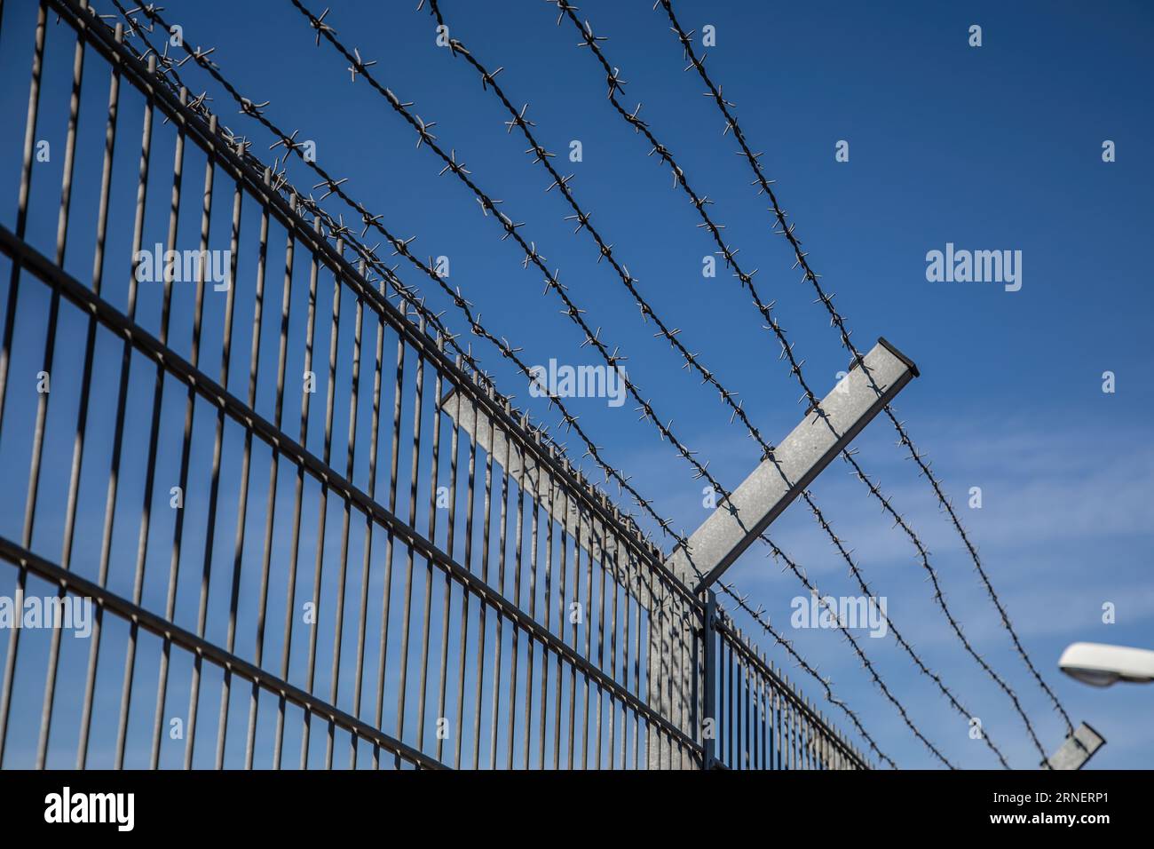 barbed wire fence too keep out burglars from home and keep in prisoners