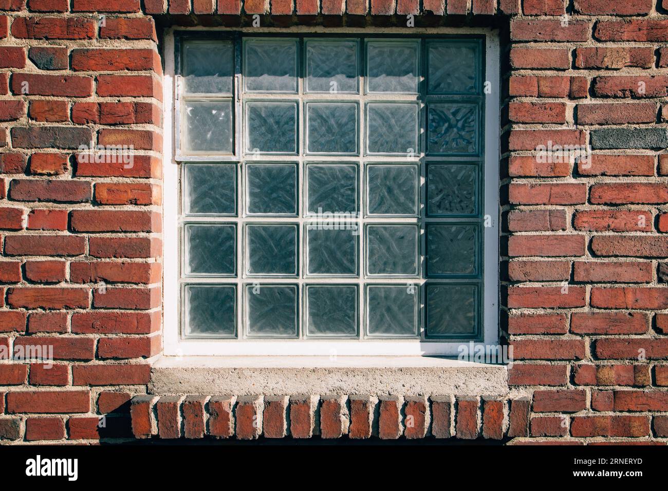 blue glass block window in red brick wall Stock Photo Alamy