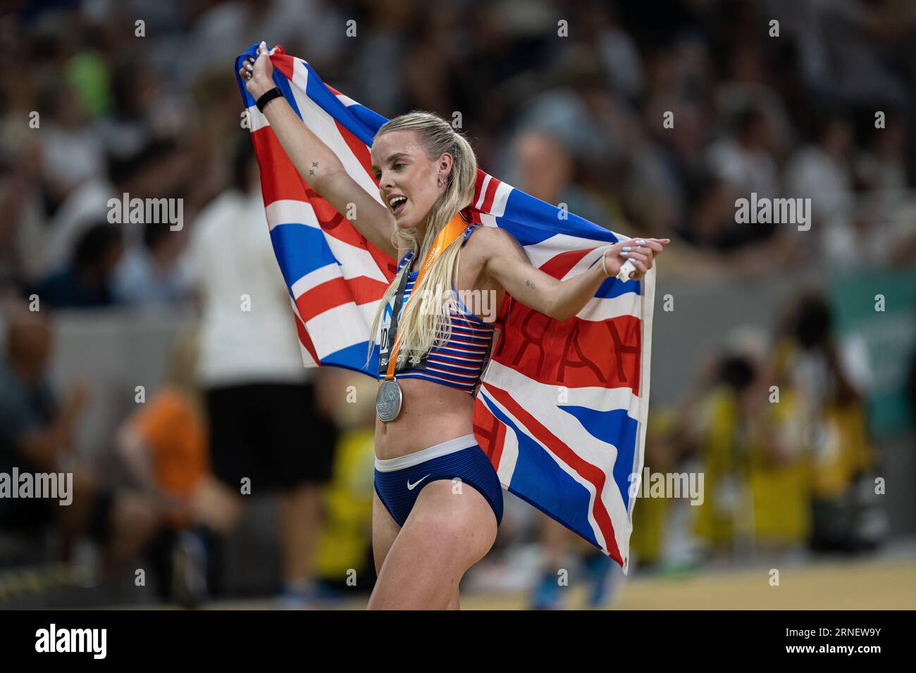 Keely Hodgkinson Celebrating Her Medal With Her Country s Flag In The keely-hodgkinson-celebrating-her-medal-with-her-country-s-flag-in-the