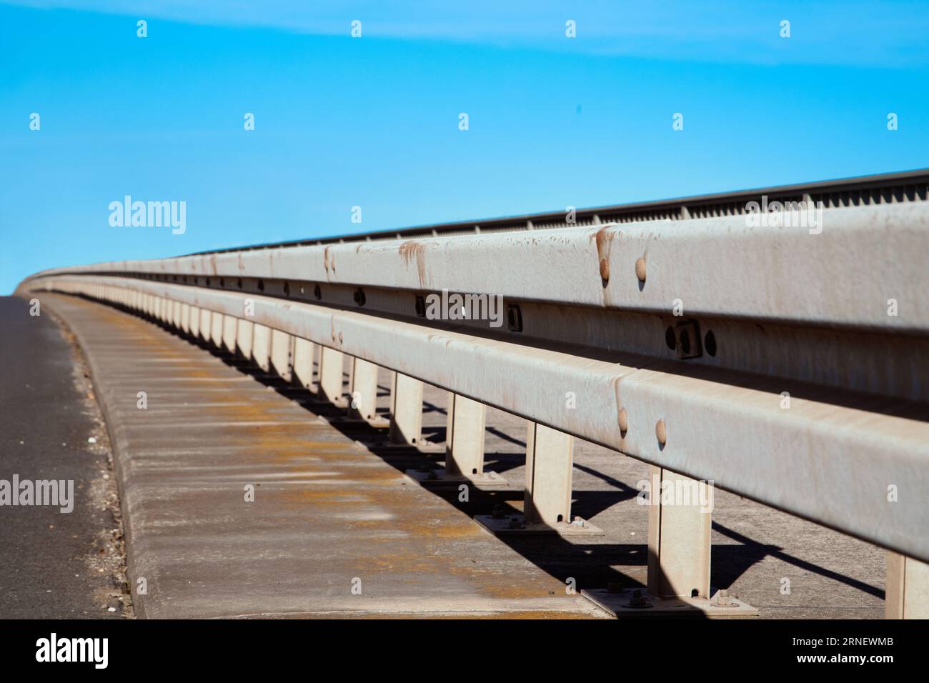 guardrail at street to prevent crash on summerday with blue sky Stock Photo