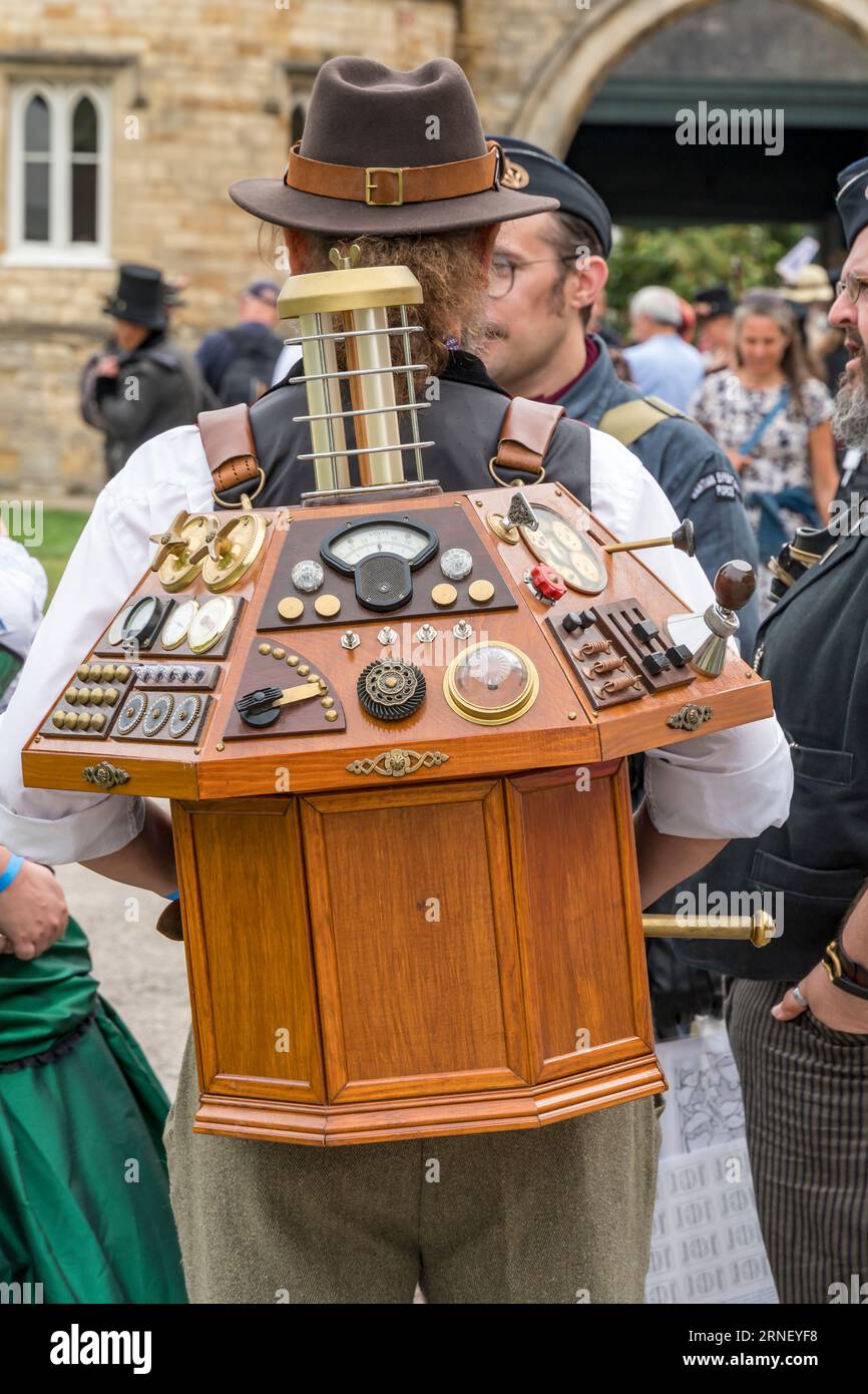 Man carrying model of Time machine control panel at Lincoln Steampunk weekend 2023, Lincoln City, Lincolnshire, England, UK Stock Photo