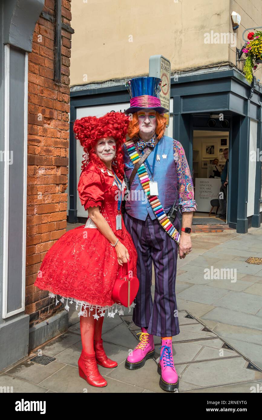 Queen of Hearts with the Mad Hatter at Lincoln steampunk weekend 2023, Bailgate, Lincoln City, Lincolnshire, England, UK Stock Photo