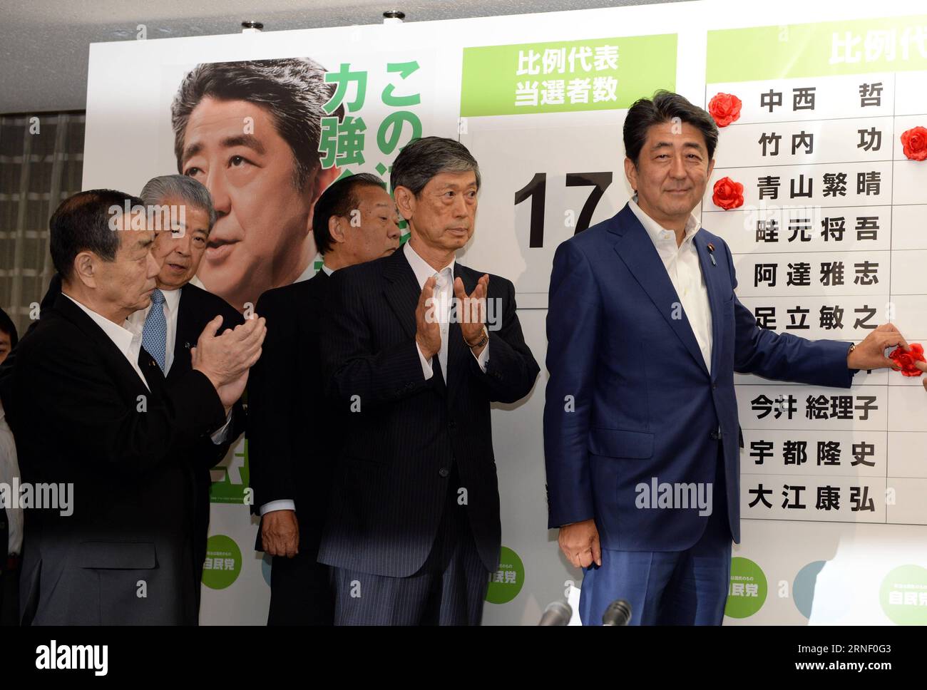 (160710) -- TOKYO, July 10, 2016 -- Japan s Prime Minister and leader of the ruling Liberal Democratic Party (LDP) Shinzo Abe (1st R) puts a rosette on the name of a candidate who is expected to win in the upper house election, at the LDP headquarters in Tokyo, Japan, July 10, 2016. The Japanese ruling camp led by Prime Minister Shinzo Abe is expected to win a majority in Sunday s upper house election, according to exit polls by local media. ) JAPAN-TOKYO-UPPER HOUSE ELECTION-RULING CAMP MaxPing PUBLICATIONxNOTxINxCHN   160710 Tokyo July 10 2016 Japan S Prime Ministers and Leader of The ruling Stock Photo