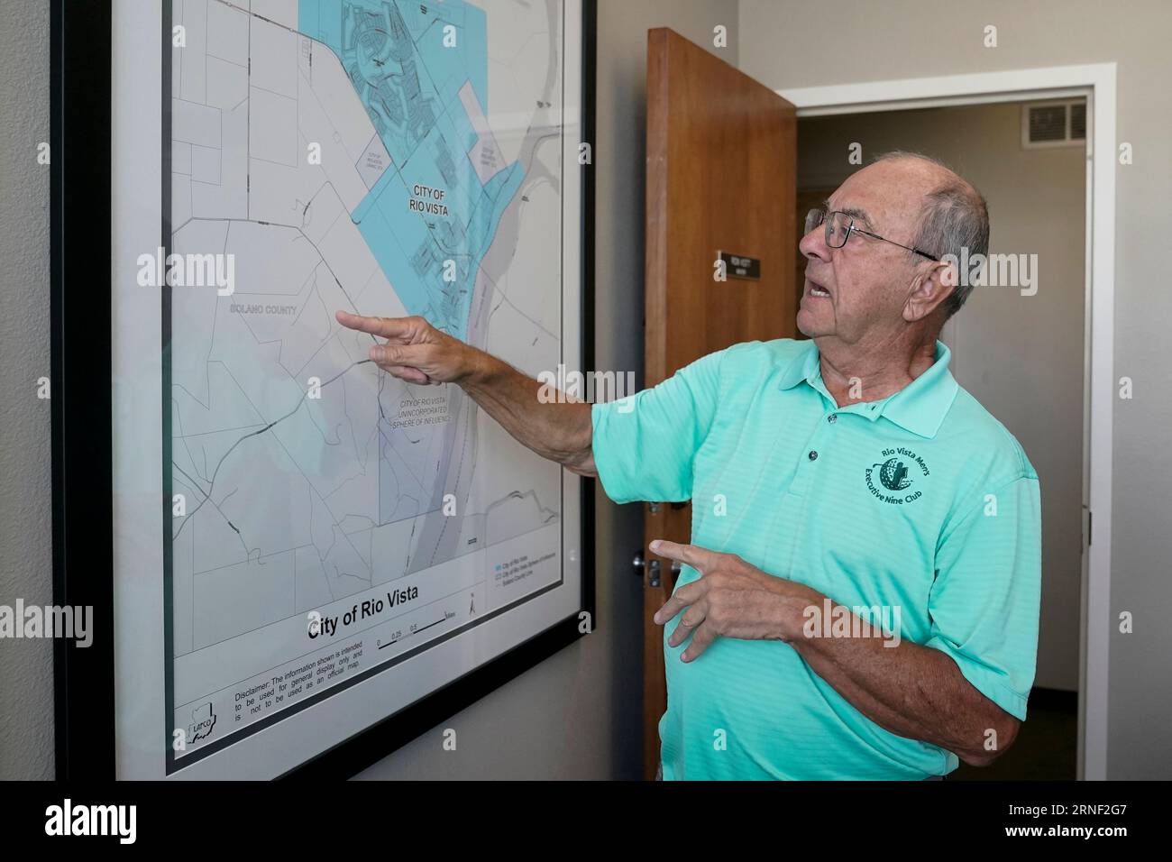 Mayor Ron Kott looks over a map of rural Solano County at City Hall in Rio  Vista, Calif., Wednesday, Aug. 30, 2023. The tech billionaires behind a  years-long, secretive land buying spree