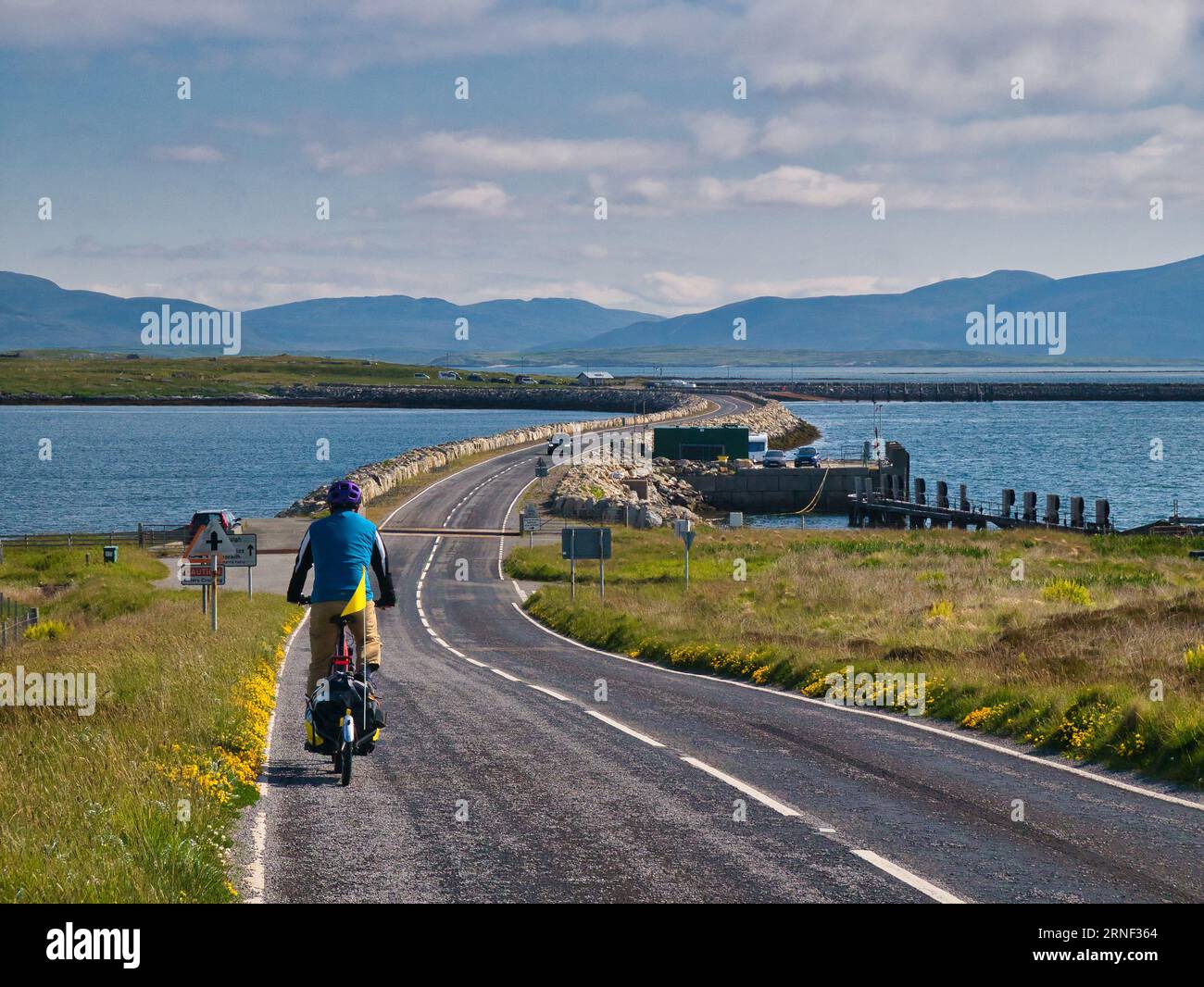 On a clear, sunny day a single cyclist heads for the causeway ...