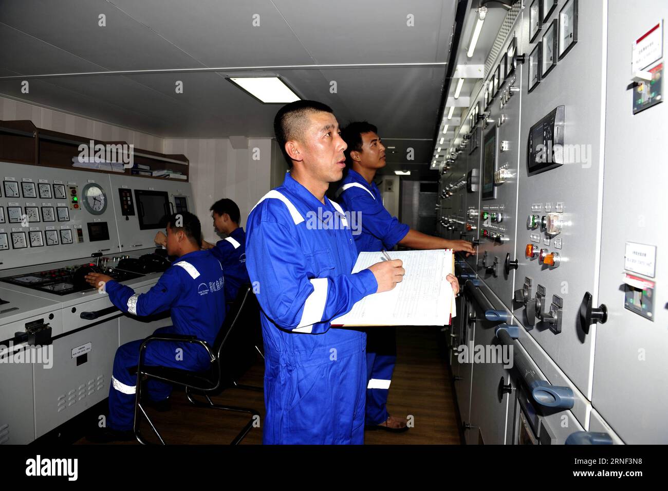 ZHANG JIAN SHIP, July 15, 2016 -- Liu Dongsheng (front), staff member of the Zhang Jian , a Chinese deep-sea explorer ship, stays on duty at the engine control room on the ship, July 15, 2016. The ship, 97 meters long and 17.8 meters wide, set sail on July 12 from Shanghai to the South Pacific for scientific research. It s the mother ship of the 11,000-meter Rainbow Fish submersible, which Chinese researchers are preparing to send to the Mariana Trench late this year or early next year. ) (mp) CHINA-EXPLORER SHIP-LIFE (CN) ZhangxJiansong PUBLICATIONxNOTxINxCHN   Zhang Jian Ship July 15 2016 Li Stock Photo