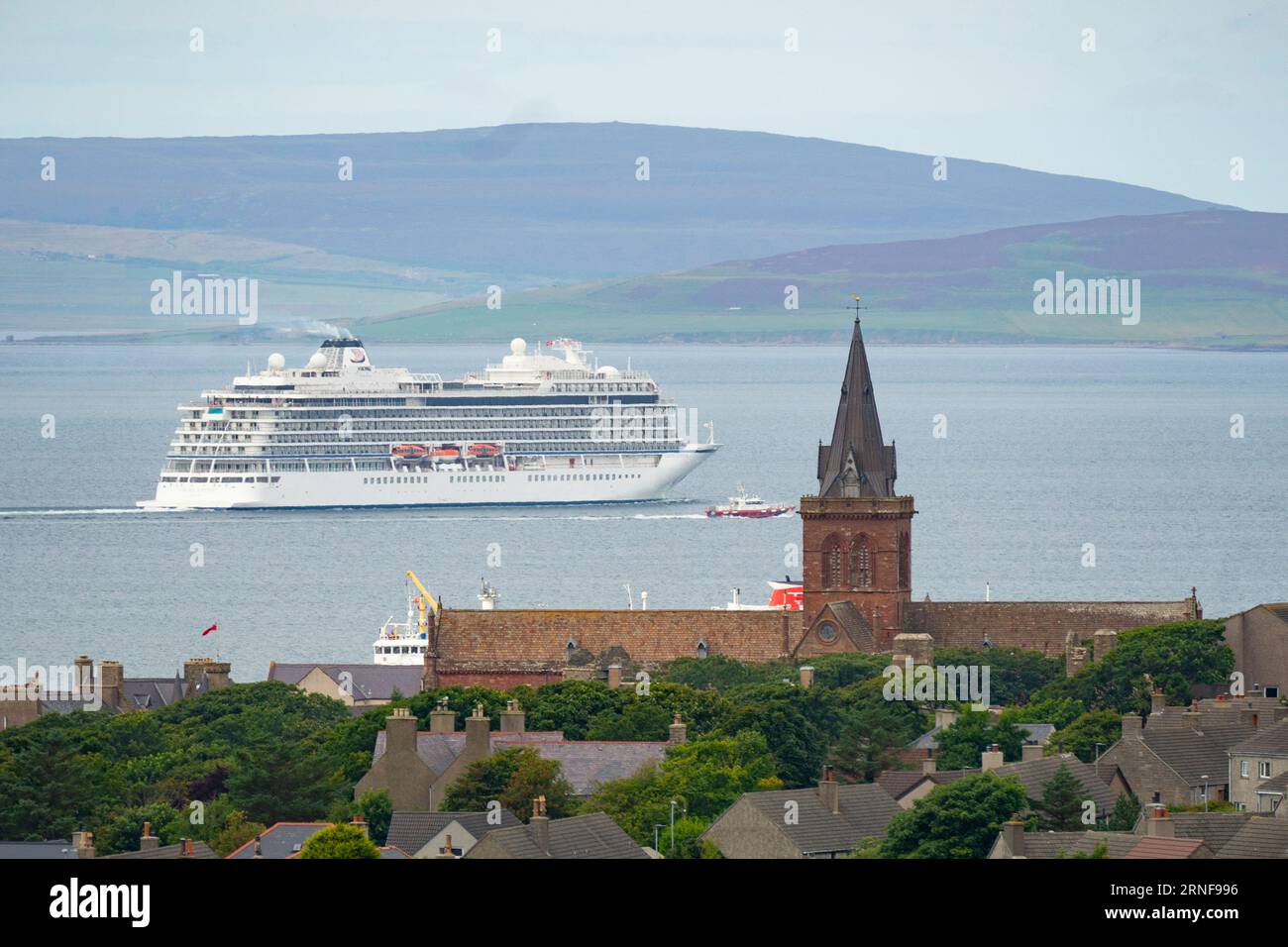 Stromness, Orkney,  Scotland, UK. 1st September 2023. American tourists from visiting cruise ships berthed at Kirkwall visit the Ring of Brodgar neolithic standing stone circle on Orkney. Concerns have been raised by locals that cruise ships are bringing too many tourists to the Islands and current infrastructure cannot cope. Pic; Cruise ship sails past St Magnus Cathedral as it leaves Kirkwall port.  Iain Masterton/Alamy Live News Stock Photo