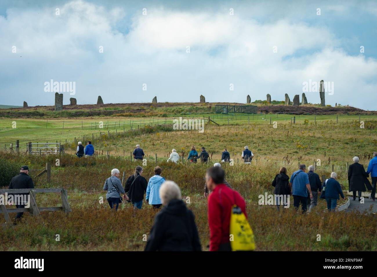 Stromness, Orkney,  Scotland, UK. 1st September 2023. American tourists from visiting cruise ships berthed at Kirkwall visit the Ring of Brodgar neolithic standing stone circle on Orkney. Concerns have been raised by locals that cruise ships are bringing too many tourists to the Islands and current infrastructure cannot cope. Iain Masterton/Alamy Live News Stock Photo