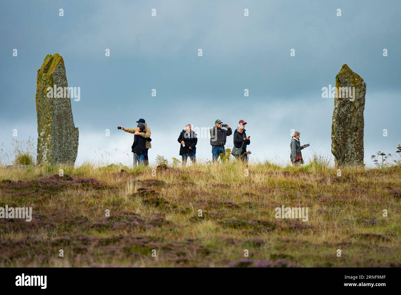 Stromness, Orkney,  Scotland, UK. 1st September 2023. American tourists from visiting cruise ships berthed at Kirkwall visit the Ring of Brodgar neolithic standing stone circle on Orkney. Concerns have been raised by locals that cruise ships are bringing too many tourists to the Islands and current infrastructure cannot cope. Iain Masterton/Alamy Live News Stock Photo