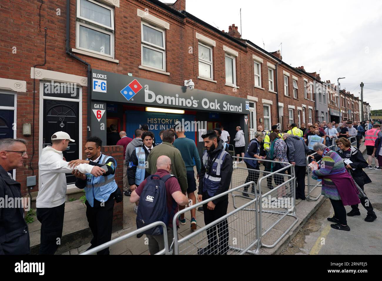 Fans queue at the Domino's Oak Stand ahead of the Premier League match