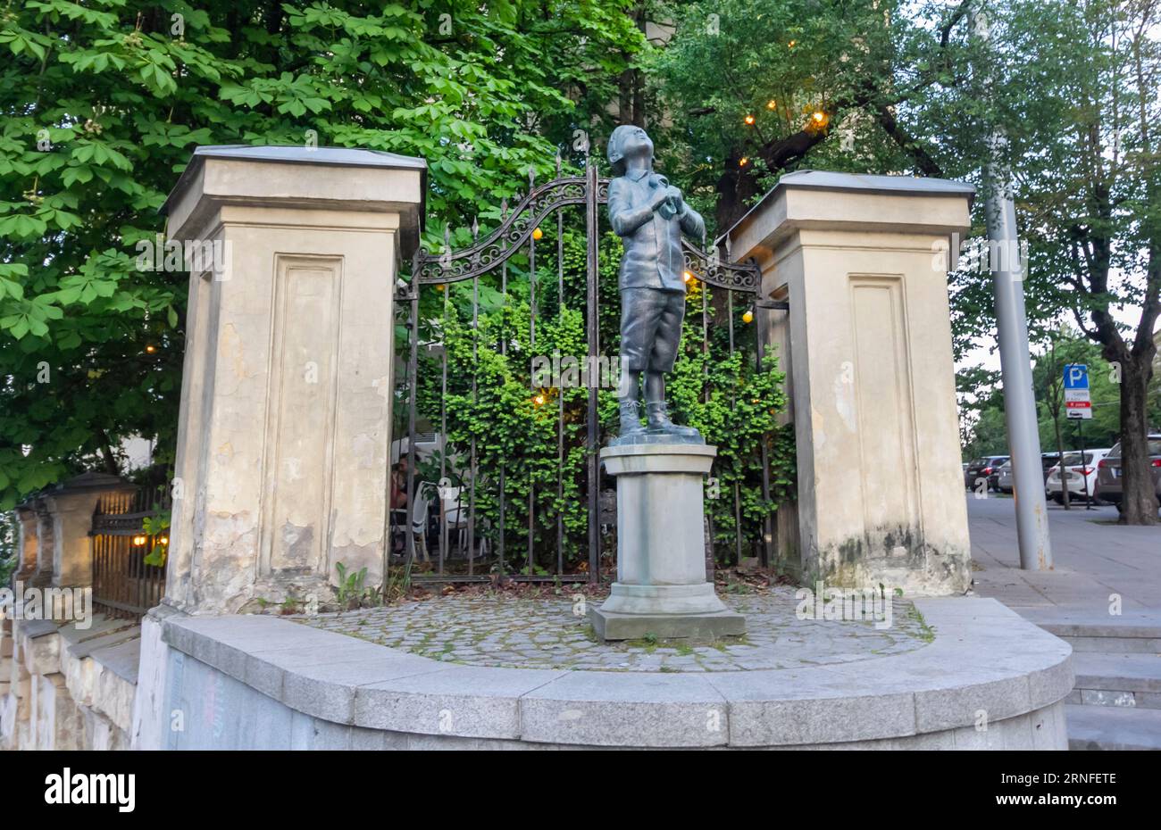 Vilnius, Lithuania - June 13, 2023: Bronze statue of Romain Gary of a boy clutching a galosh and looking up at the sky Stock Photo