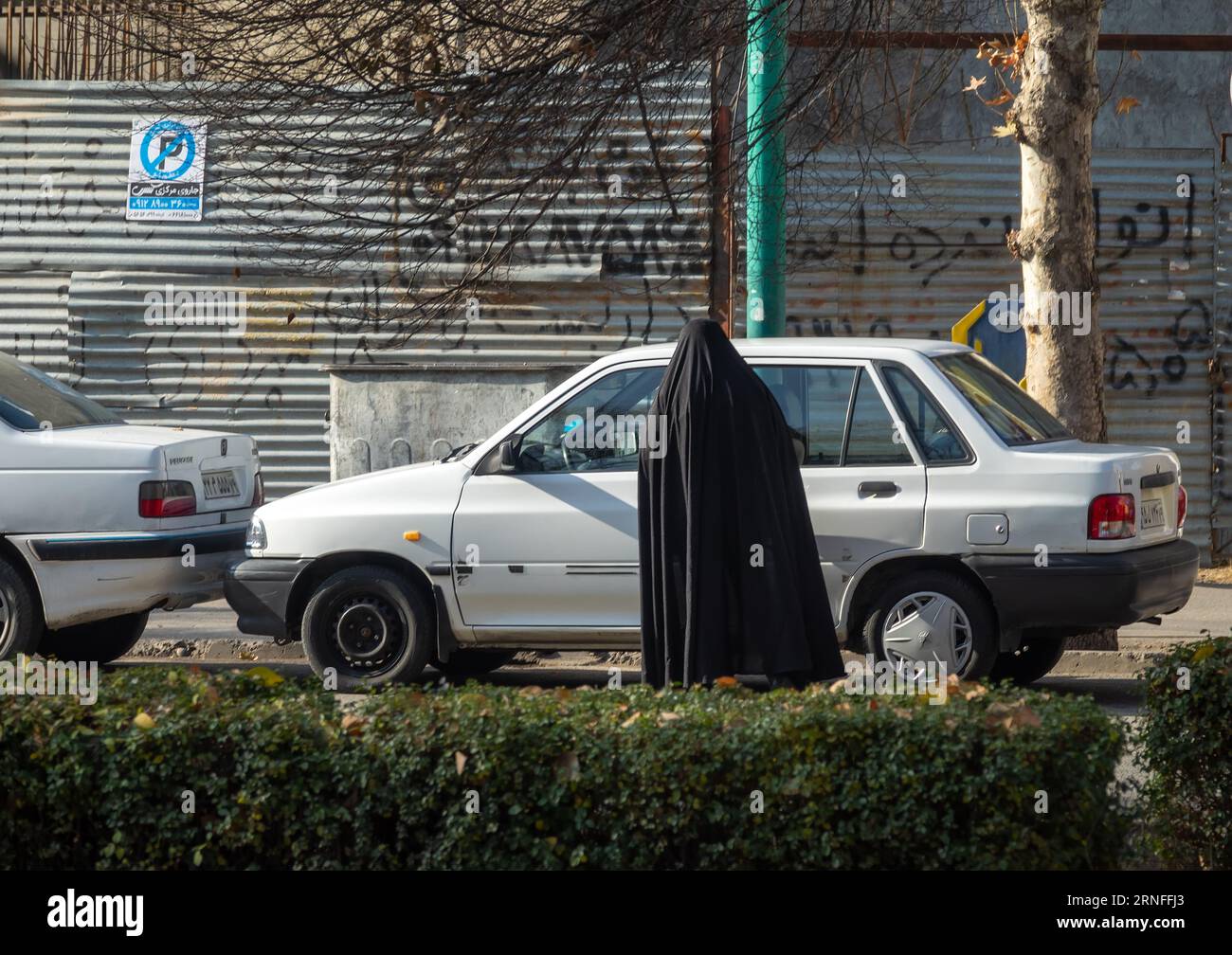 Qazvin, Iran- December 18, 2022: On the streets of the Iranian city. Iranian women in burnous according to Iranian Muslim laws in coronavirus period p Stock Photo