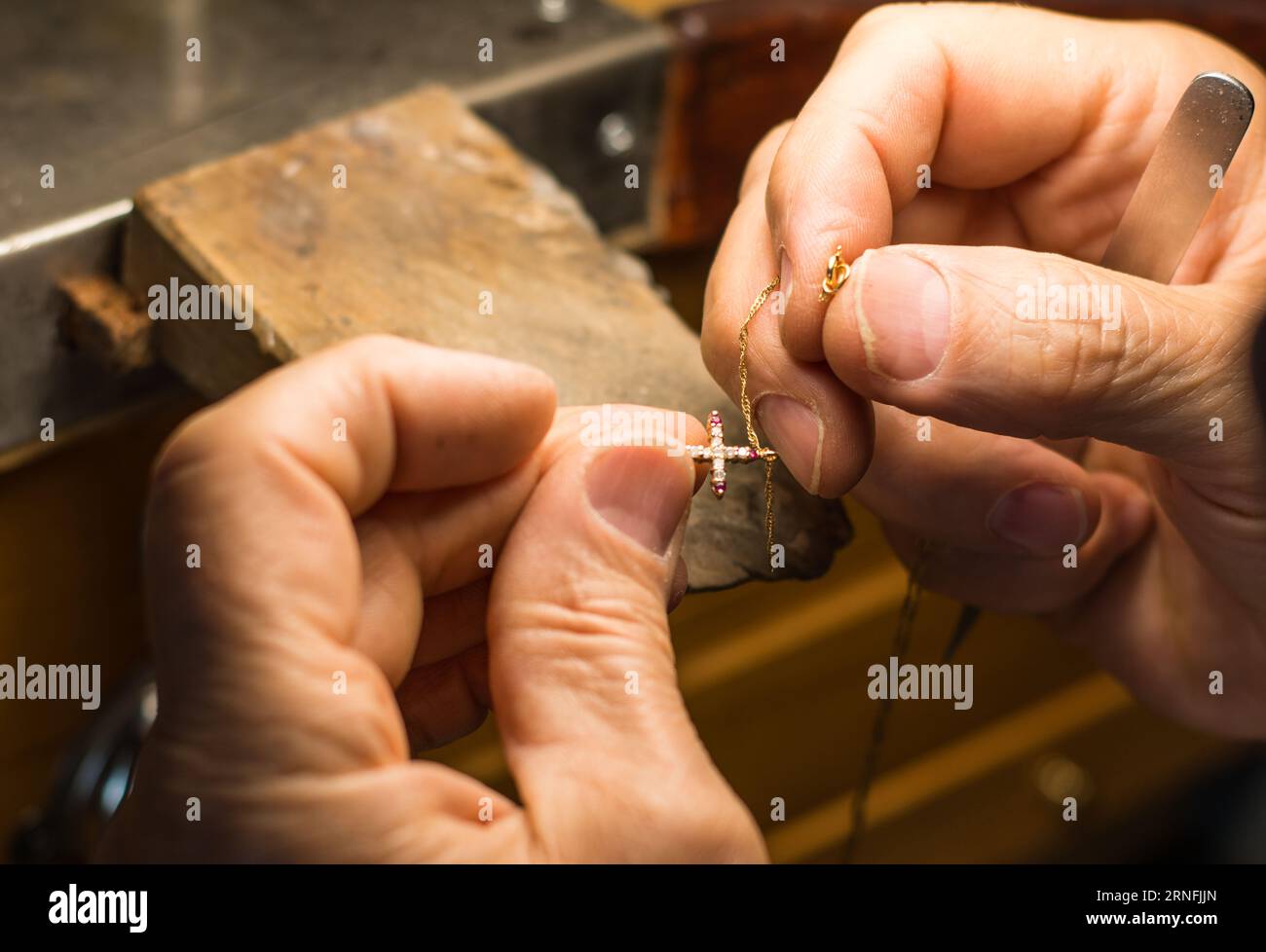 Hands of an artisan jeweler working jewelry. Jewelry Goldsmith Stock Photo