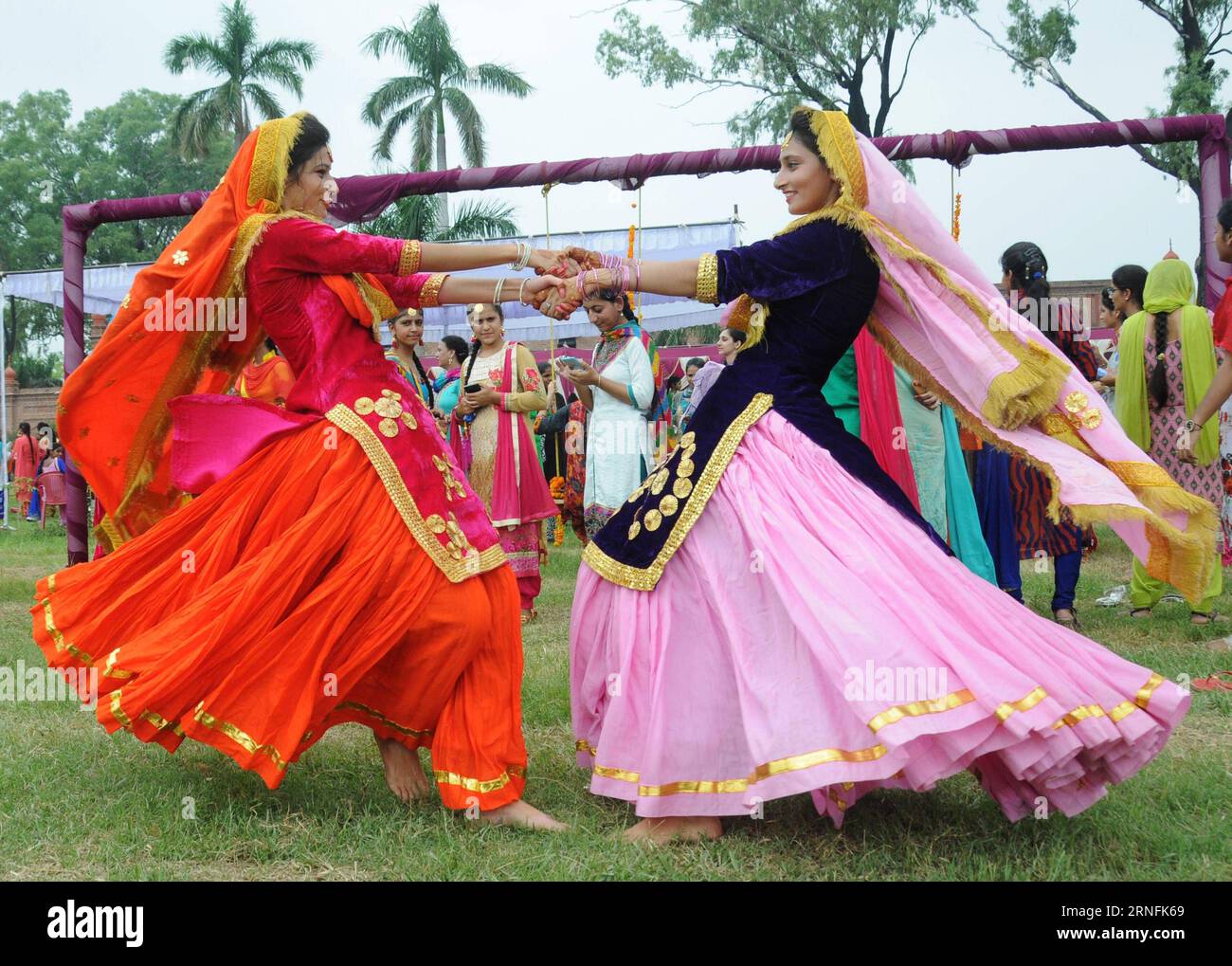 (160813) -- AMRITSAR (INDIA), Aug. 13, 2016 -- College girls wearing traditional Punjabi dresses dance during the celebration of Teej Festival in Amritsar, India, Aug. 13, 2016. Teej is a generic name for a number of festivals celebrated among females to welcome monsoon season in northern and western India and Nepal. ) (wtc) INDIA-AMRITSAR-TEEJ FESTIVAL-CELEBRATION stringer PUBLICATIONxNOTxINxCHN   160813 Amritsar India Aug 13 2016 College Girls Wearing Traditional Punjabi Dresses Dance during The Celebration of Teej Festival in Amritsar India Aug 13 2016 Teej IS a generic Name for a Number of Stock Photo