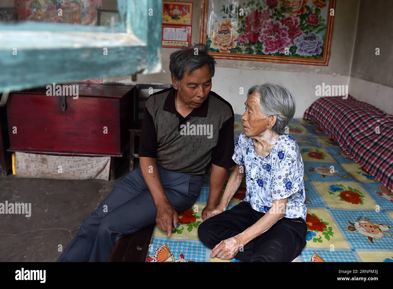 (160815) -- TAIYUAN, Aug. 15, 2016 -- Zhang Shuangbing, a village teacher who volunteered to investigate about the suffering and life of surviving comfort women in China for 34 years, talks with Liu Fenghai, a woman who was forced to serve as a comfort woman during the Second World War, in Yu County, north China s Shanxi Province, Aug. 3, 2016. Monday marked the 71st anniversary of Japan s unconditional surrender at the end of World War II. Some 400,000 women in Asian were made into comfort women for the Japanese army during WWII, nearly half of which are Chinese, according to a research cente Stock Photo
