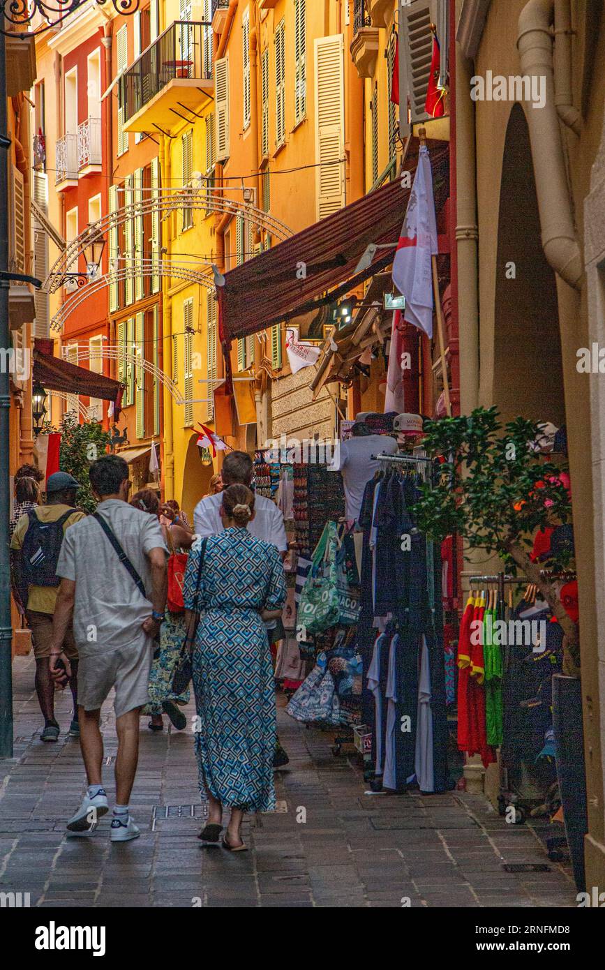 Crowds of tourists amongst he beautiful colourful houses of Monaco old town Stock Photo